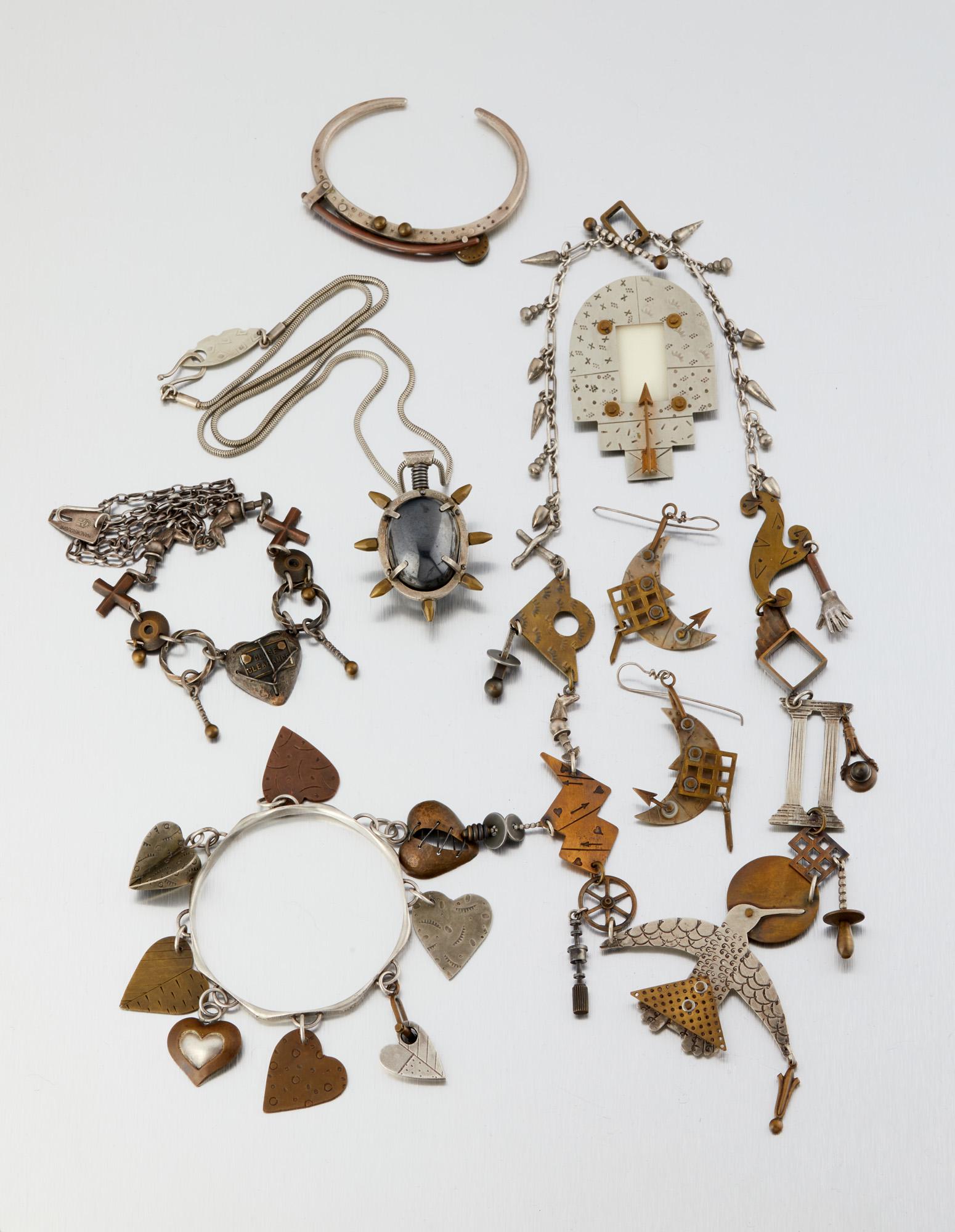 A group of Thomas Mann mixed-metal jewelry items: Fourth quarter 20th century Each stamped for Thomas Mann Comprising two bracelets (larger: 7.5" C x 1.125" H, smaller: 6.5" C, wrist opening: .875"); Three necklaces (largest: 23" L x 3.5" H, smalle