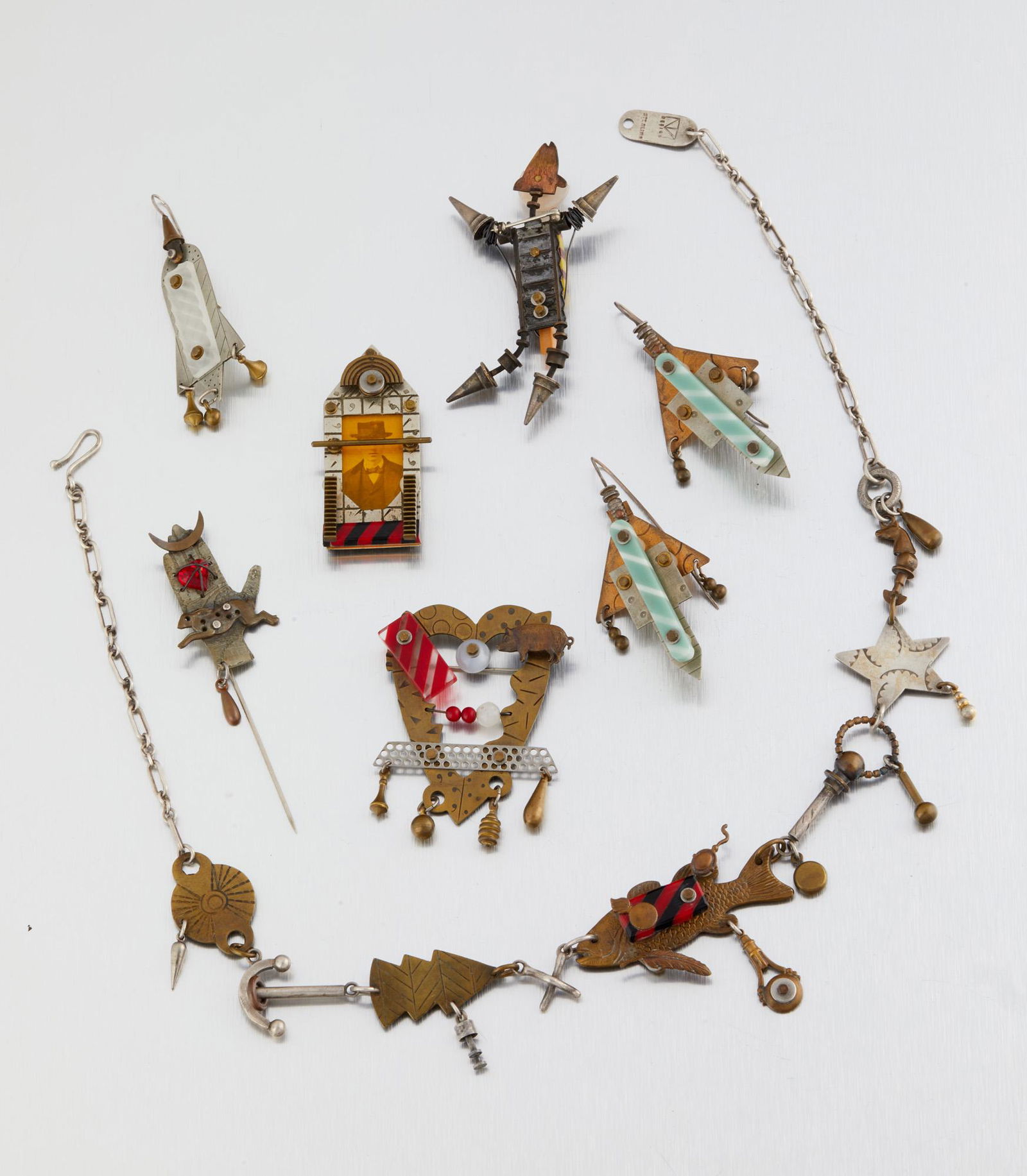 A group of Thomas Mann jewelry items: Fourth quarter 20th century Each signed for Thomas Mann; Scattered elements stamped: Sterling Comprising a necklace, a pair of earrings, a single earring, a stick pin, and three brooches, 7 pieces