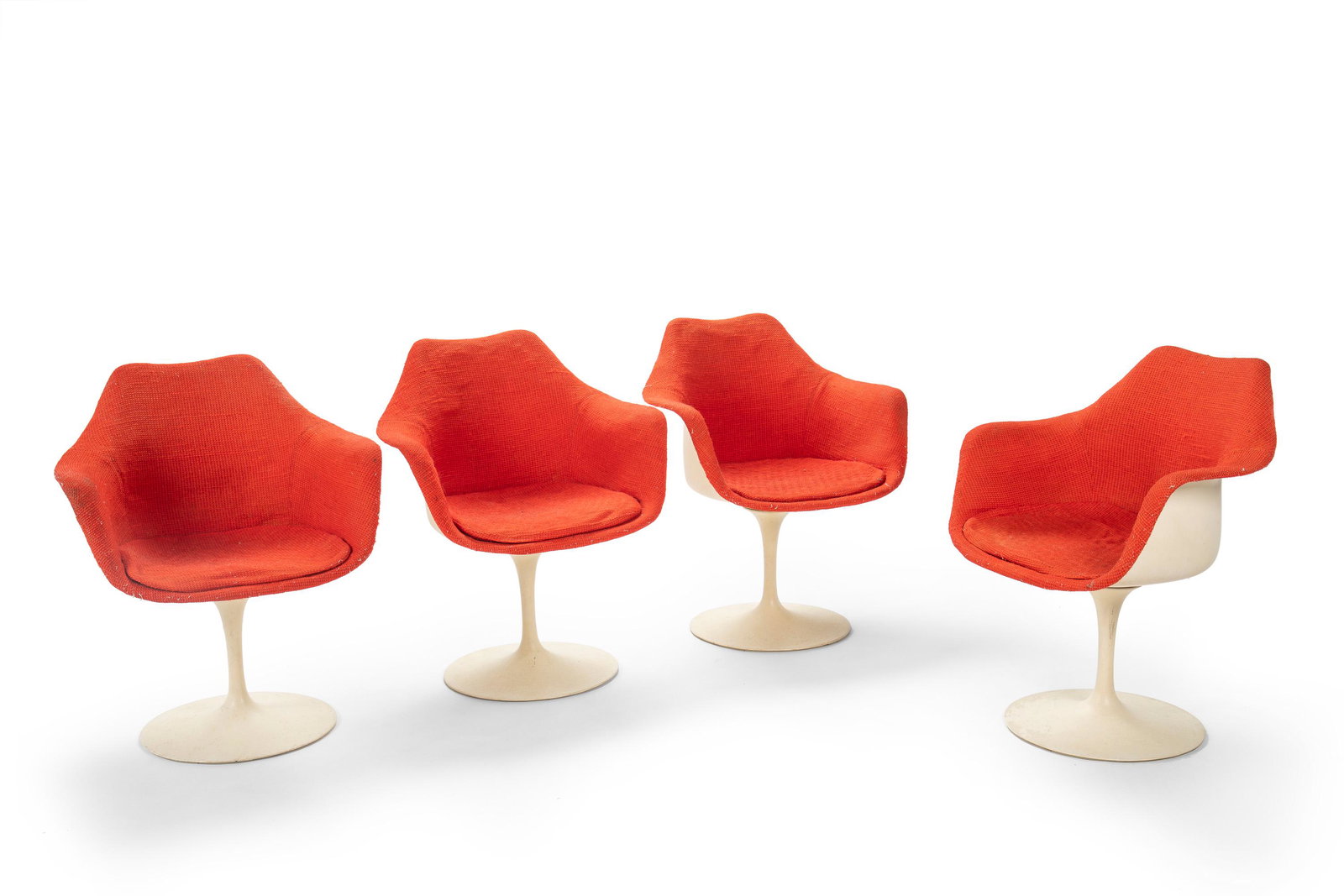 A set of four Eero Saarinen for Knoll "Tulip" swivel: 1973 Marked to underside of base: BR 50; Each cushion further marked for Knoll International: March 21, 1973 The fiberglass, aluminum, and carnelian red hopsack-linen fabric chairs with removable cush