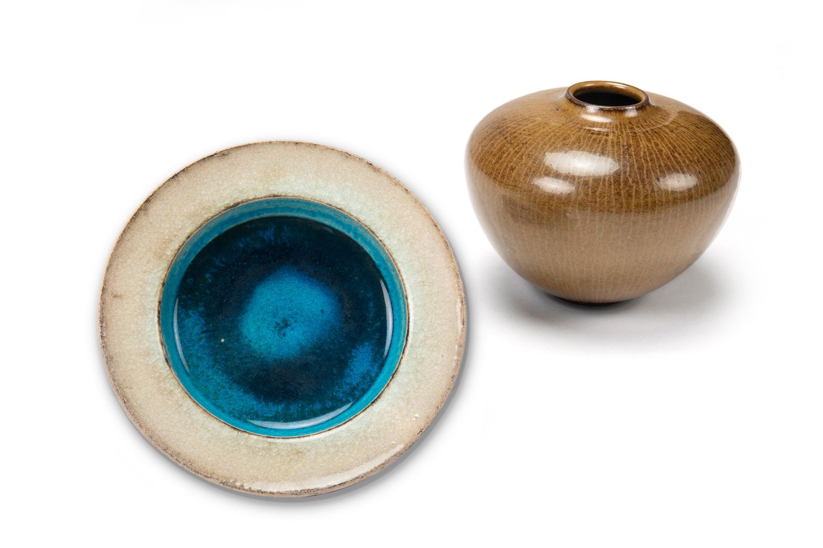A group of two European pottery pieces: Second-half 20th Century Smaller stamped: Kahler / HAK Danmark; Larger signed with makers mark for Nils Thorsson A Herman Kahler small dish with teal blue together with a Nils Thorsson brown BACA pa