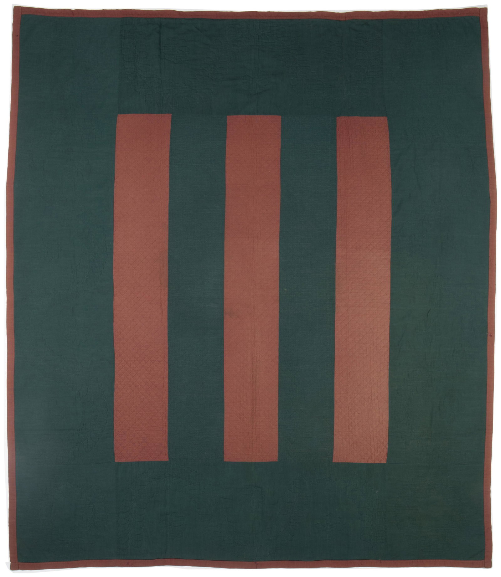 An Amish Floating Bars quilt: Circa 1880, Lancaster County, Pennsylvania Henrietta wool and cotton with brown bars floating on green field, quilted in crosshatching, diamonds, feathered wreaths, and feathered garlands with a grey 