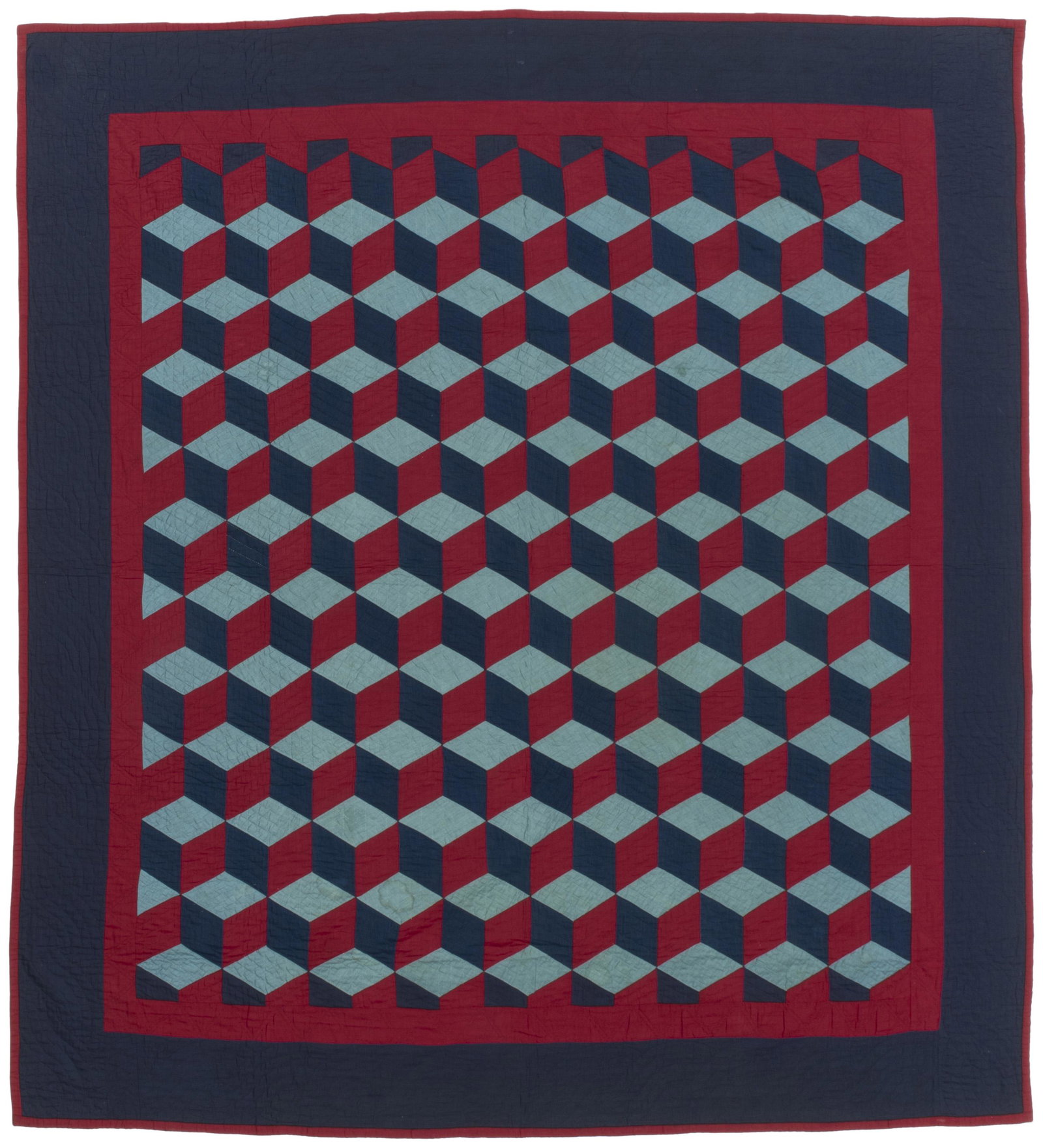 An Amish Tumbling Blocks quilt: 1890-1900, Geiger County, Ohio Made by The Smucker Family Cotton with tumbling blocks in light and dark blue and red, all set within a red inner border , dark blue outer border, and red binding edge, 