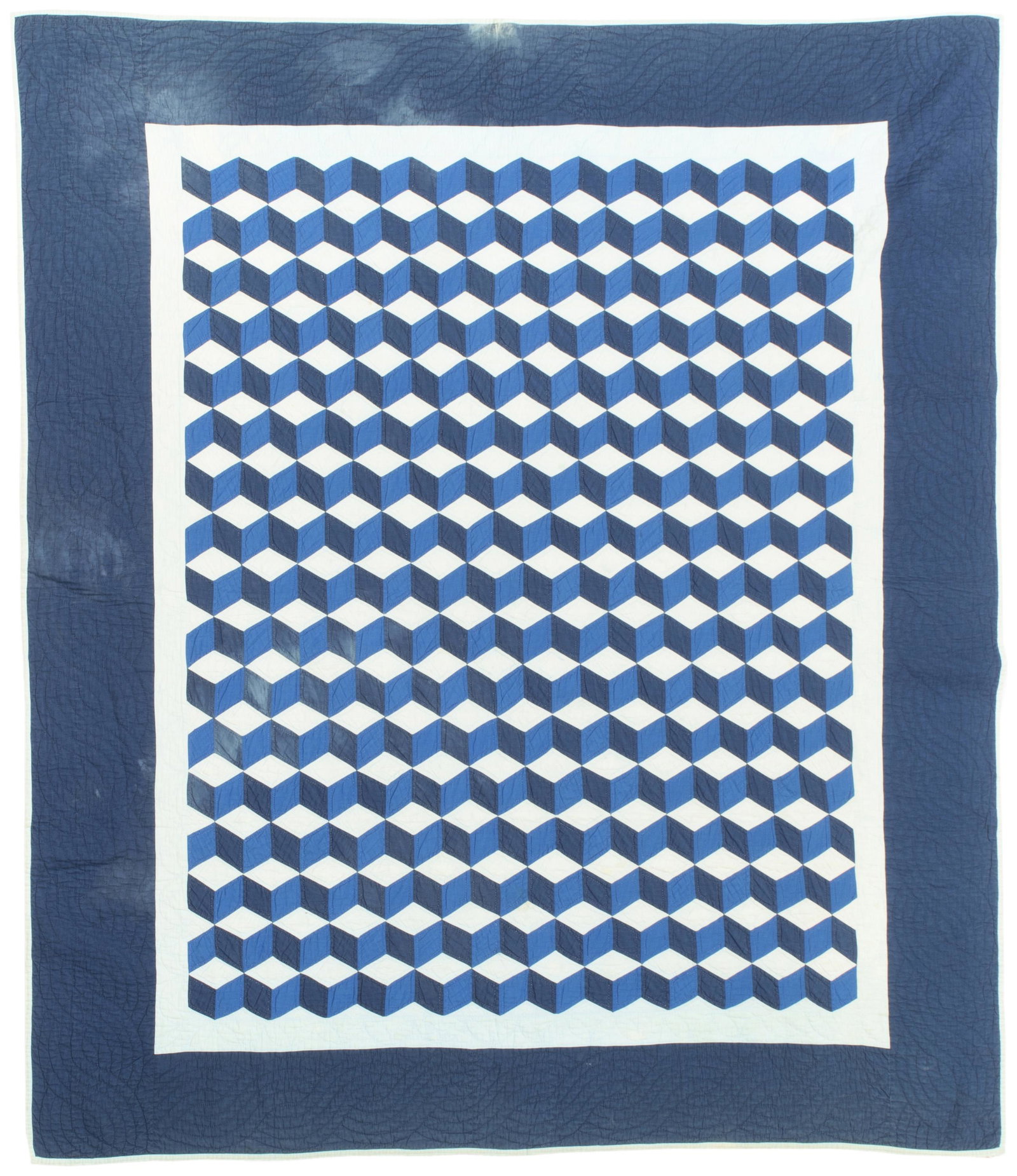 An Amish Tumbling Block quilt: 1920-1930, Ohio Cotton with a navy border with royal, navy and light blue center motif, hand quilted in cables and leaves with a forest green backing 77" H x 88" W Provenance: The Collection of Cindy 