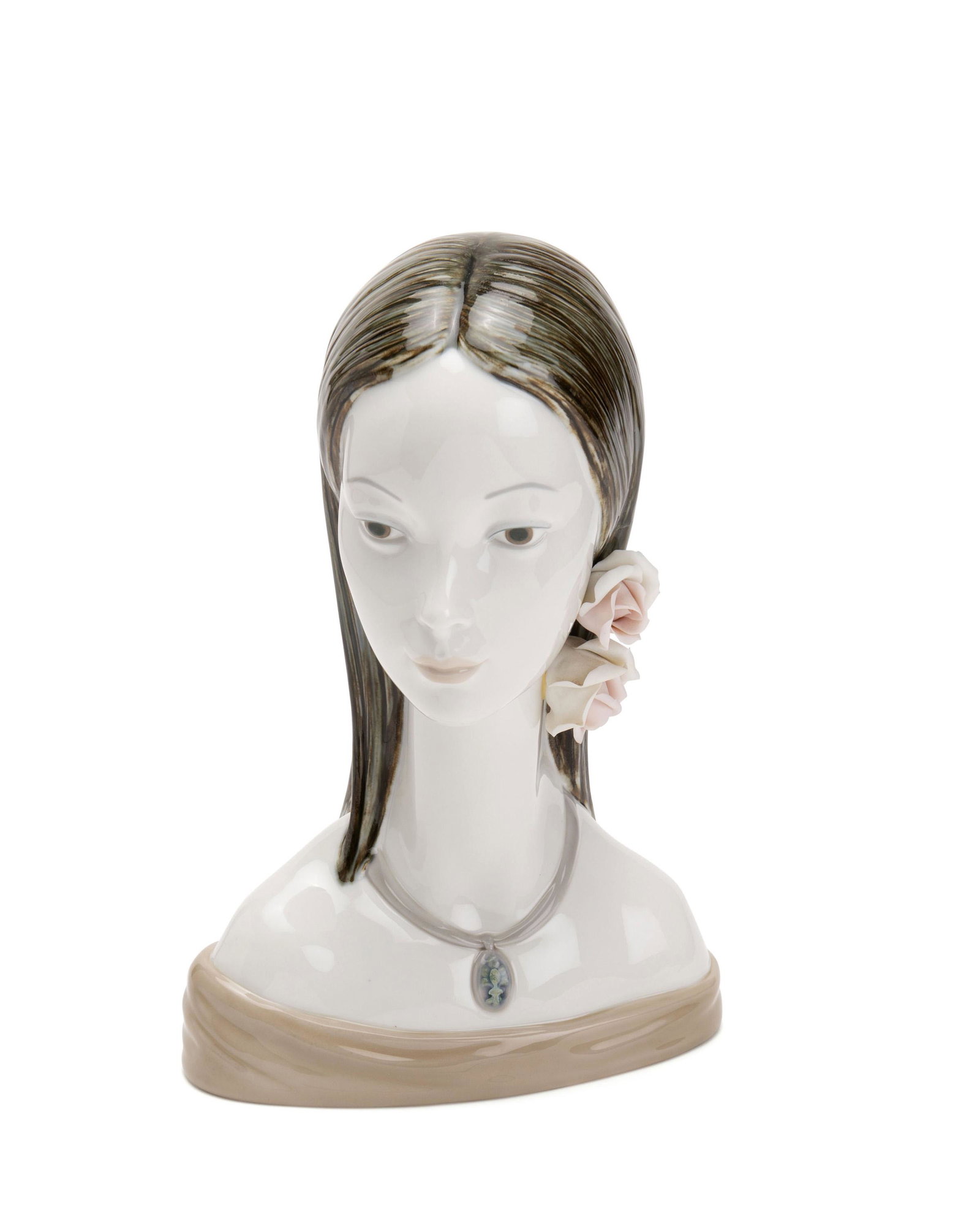 A Lladro bust of "Maja": 1970-1985 Stamped to base: Lladro / Hand Made in Spain; Further marked #4668 Designed by Juan Huerta, the bust depicts a young woman with flowers in her hair 12.25" H x 8.25" W x 5" D