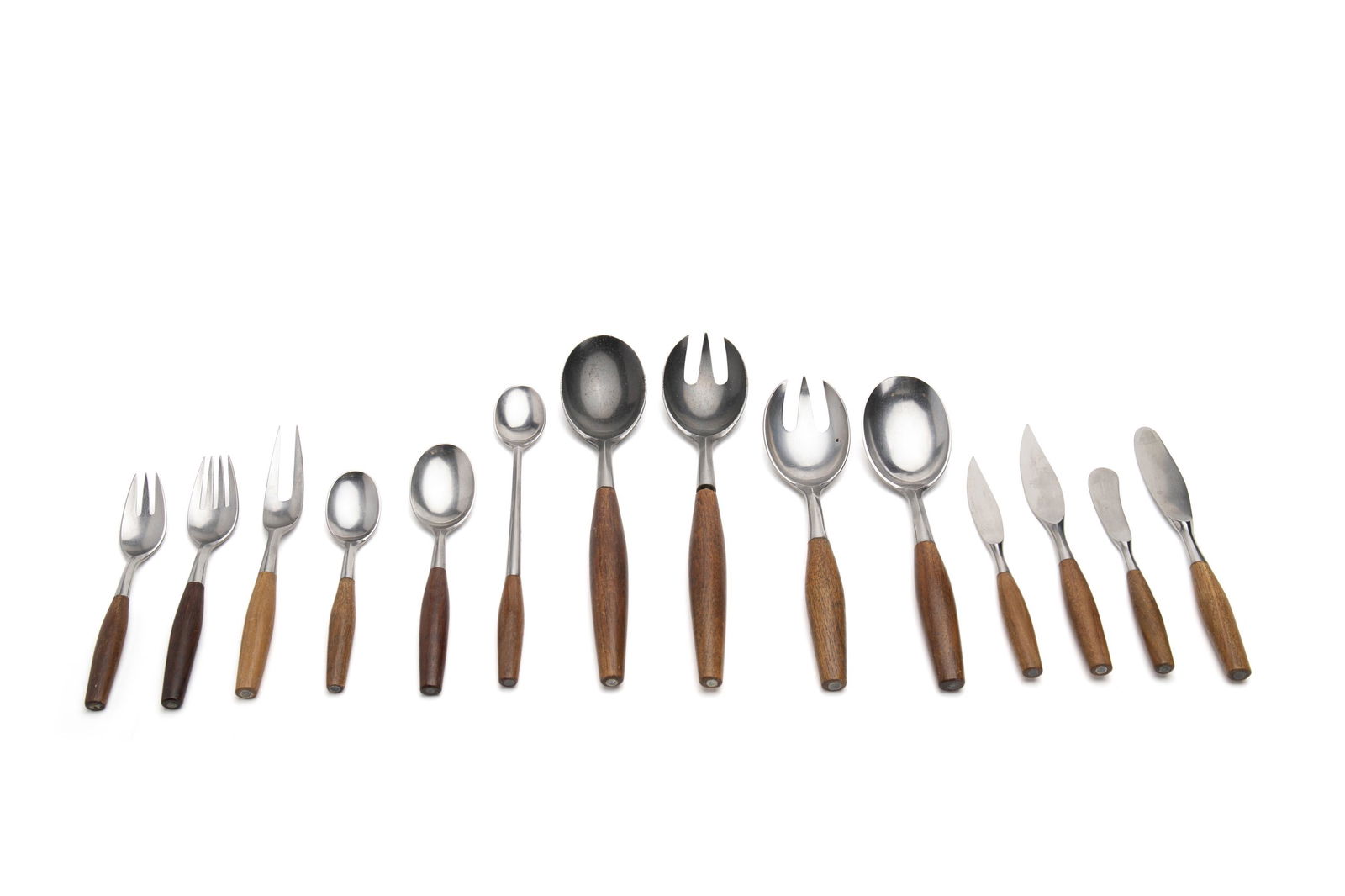 A Dansk "Classic Fjord" flatware set: Circa 1960s Each marked for Dansk Designs, Germany Originally designed in 1954 by Jens Quistgaard, the 18/10 stainless steel with teak handled design comprising 14 dinner knives (8.375"), 6 steak kn