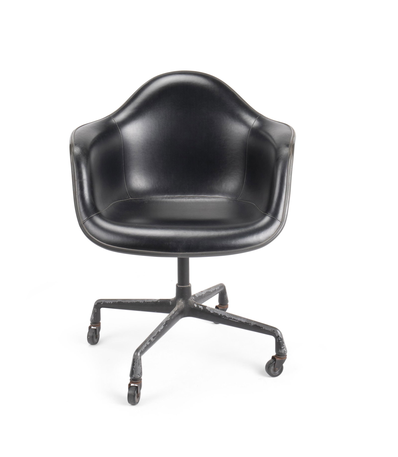 An Eames for Herman Miller shell-style arm chair: Circa 1960 With molded manufacturer's mark for Herman Miller The black fiberglass and vinyl swivel mounted chair on a black aluminum mobile base 32" H x 25" W x 22" D