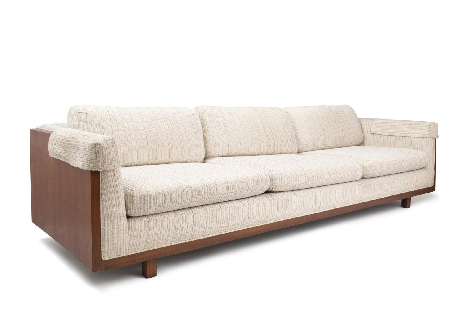 A large modern-style sofa: 1970s The cream-colored woven wool sofa with walnut slab sides and footrails 29.5" H x 98" W x 34" D