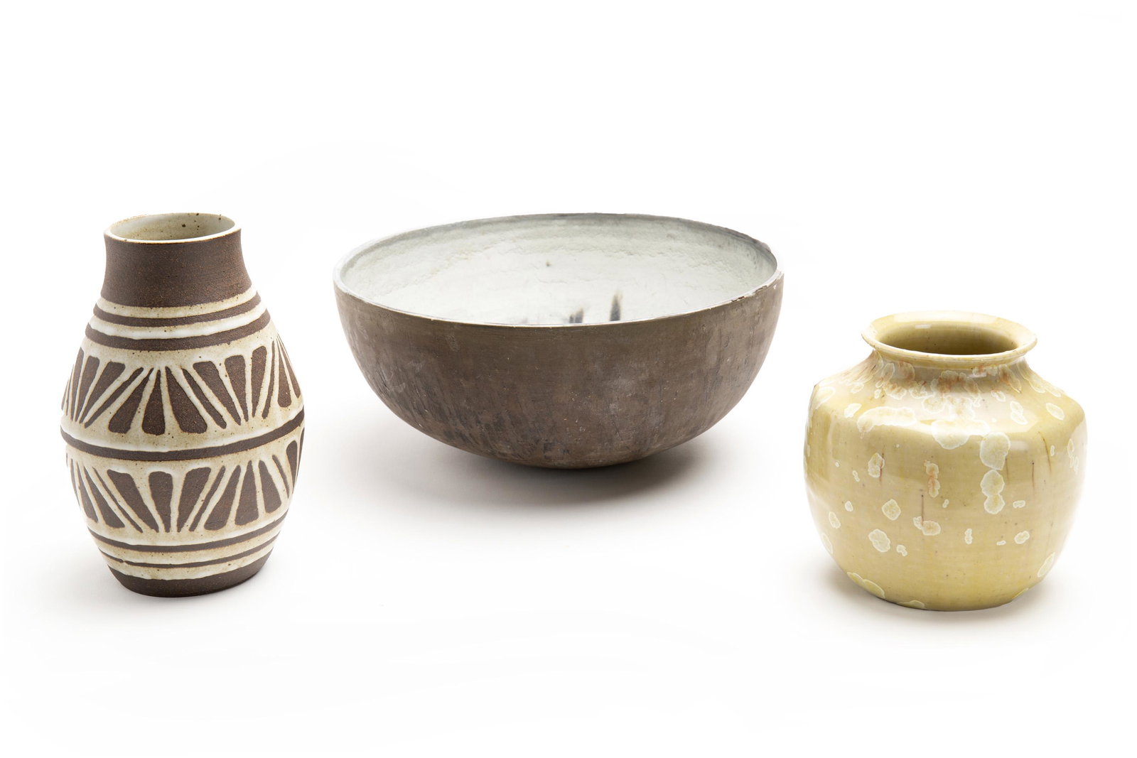 A group of three contemporary studio pots: 20th/21st Century Each signed/inscribed to base Comprising a large low bowl with grey interior and painted design signed Jargen Frank to base, a tall dark brown earthenware pot with applied white glaz