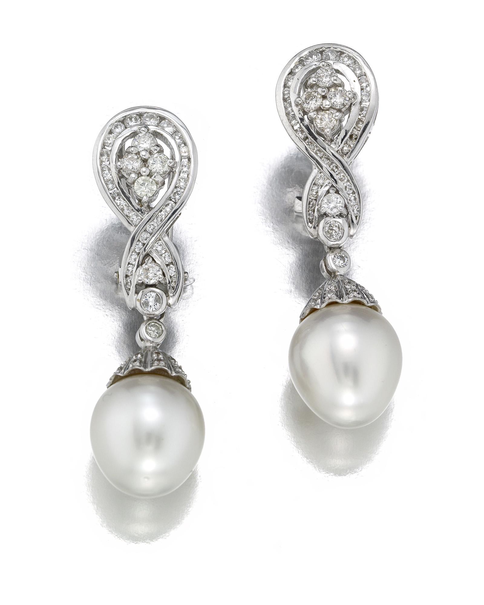 A pair of South Sea cultured pearl and diamond: 18k white gold Each omega-back earring with removable South Sea cultured pearl drop set with ninety full-cut round diamonds totaling approximately 1.25 cts. and graded H-K color, SI-I clarity 1 5/8" H