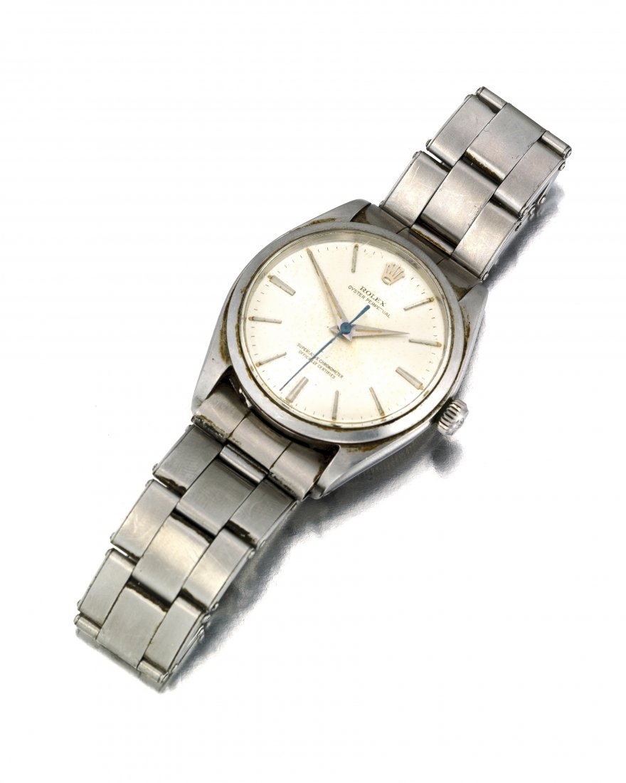 A Rolex Oyster Perpetual wristwatch: 1950 Ref: 1002 Dial: circular silvered sunburst dial, signed Rolex / Oyster / Perpetual / Superlative / Chronometer / Officially / Certified, chrome polished luminous dauphine hands, black center sw