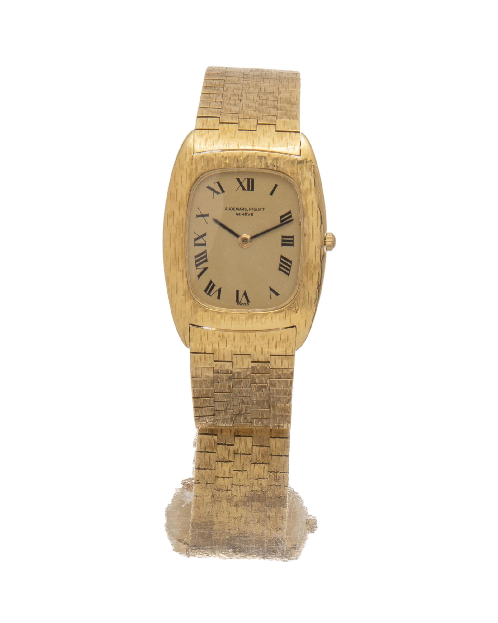 A gents Audemars Piguet Geneve gold wristwatch: 1960s Dial: Ellipse shape, champagne dial with black Roman numerals, signed Audemars / Piguet / Geneve, black stick hands Movement: 17 jewel manual stem wind and set movement, time only, Cal: 2003, #1