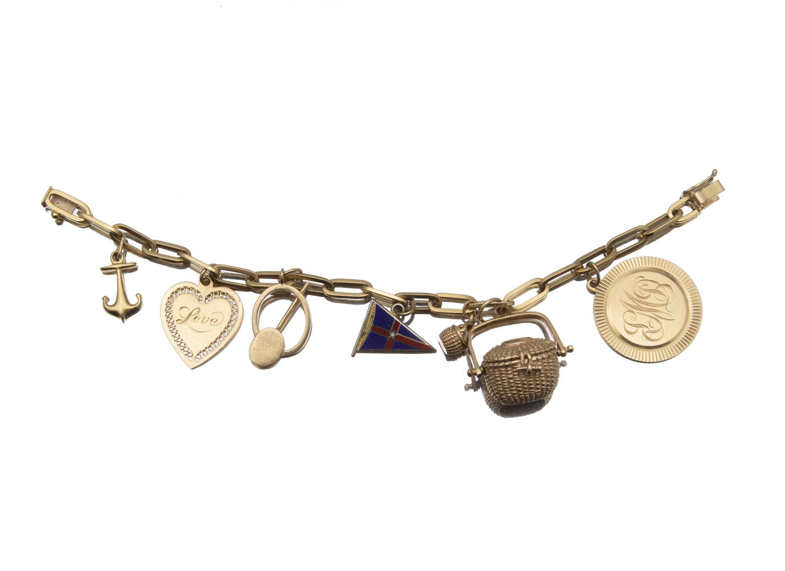 A yellow gold charm bracelet: 18k yellow gold Set with seven various charms comprising one 18k yellow gold anchor charm, five 14k yellow gold charms, and one silver and enamel flag charm 7 1/4" L x 1 1/8" H 38.5 grams