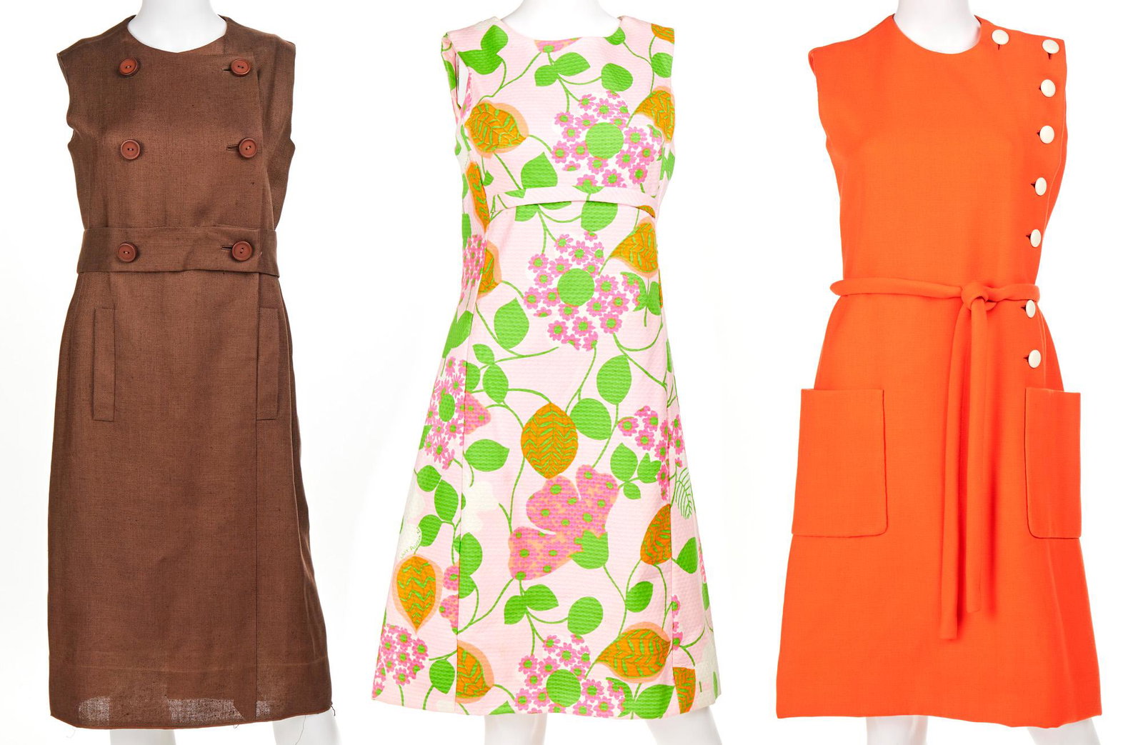 Three vintage sleeveless day dresses: Circa 1960s Each with fabric label Comprising one Lily Pulitzer dress a brown Norman Norell dress, and an orange Norman Norell dress, 3 pieces