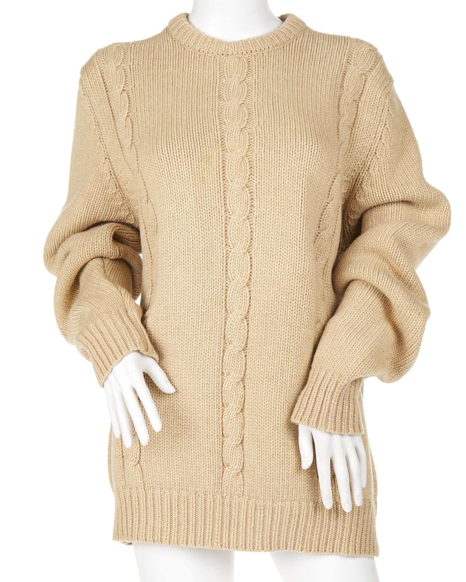 An Hermes cable-knit sweater: Fourth quarter 20th century Fabric label: Hermes Paris / Made in Scotland The tan cashmere sweater with cable-knit design Size: Medium