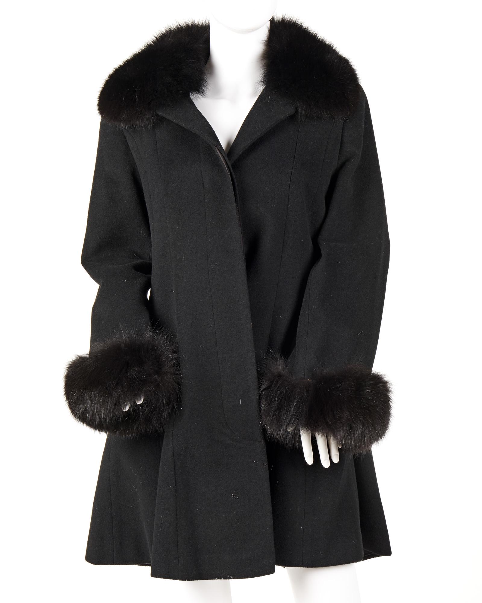 A Marvin Richards fur-trimmed jacket: Fourth quarter 20th century Fabric label: Marvin Richards / Made in USA The black fur collar and cuffs set into a black wool trapeze coat Shoulder to shoulder: 17"; Armpit to armpit: 21"; Collar to he