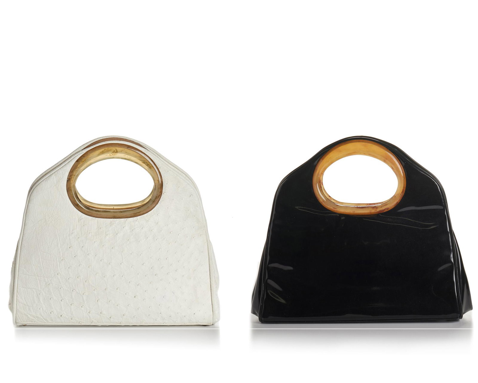 Two vintage Holzman leather bags: Third quarter 20th century Each stamped for maker Comprising a black patent leather bag and a white ostrich leather bag, 2 pieces Each approximately: 13" H x 14.5" W x 3.5" D