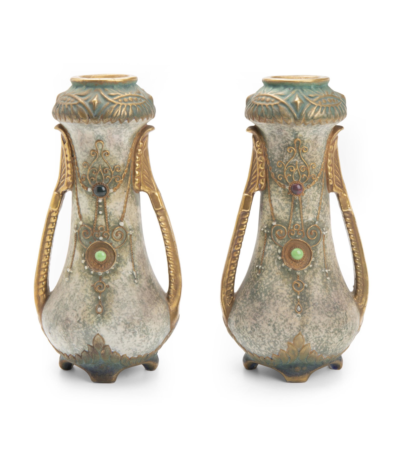 A pair of Amphora vases: Circa1900; Austria One marked indistinctly to base: Austria / Amphora / 11629; One further labeled with remnants of makers tag Each two-handled Art Nouveau polychromed glazed ceramic vase with jeweled