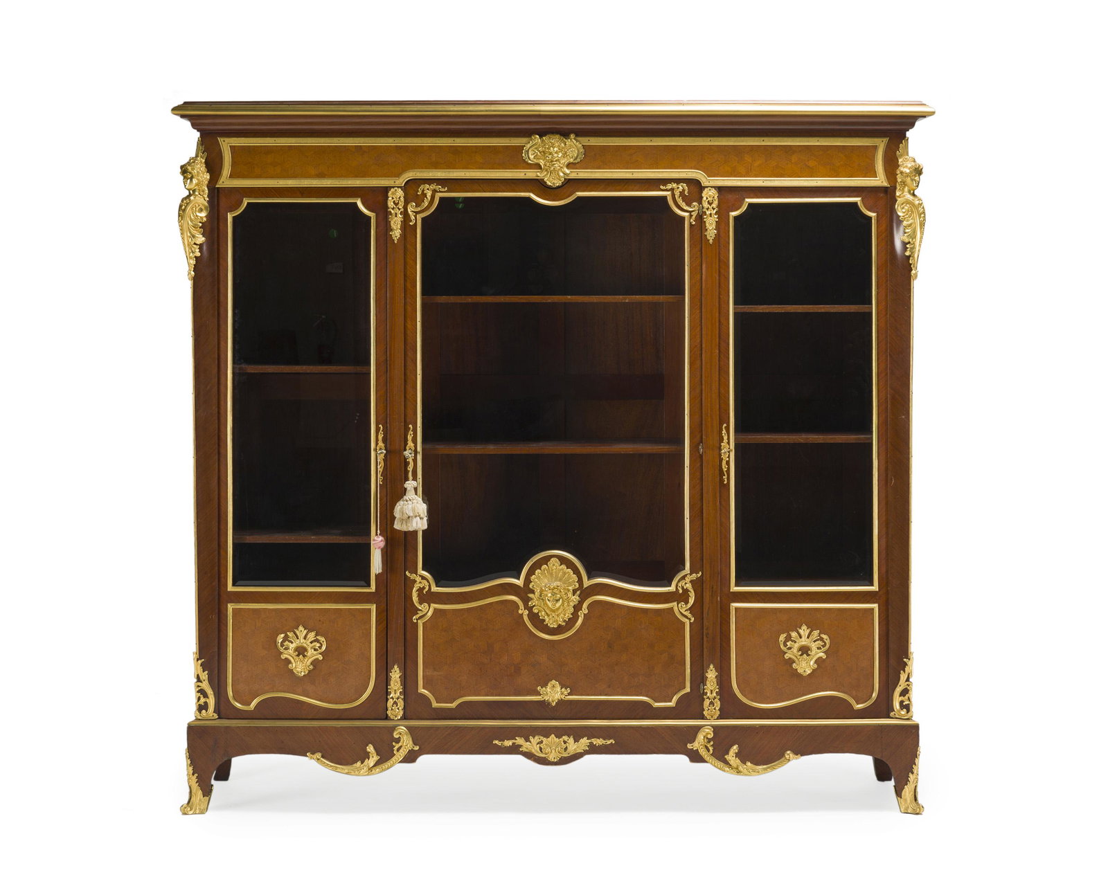 A French Millet a Paris marquetry bookcase: Fourth-quarter 19th Century Signed to one bronze mount: Millet a Paris The molded top over a gilt-bronze mounted body with parquetry panels issuing three glazed doors, set with wood shelves, and raise