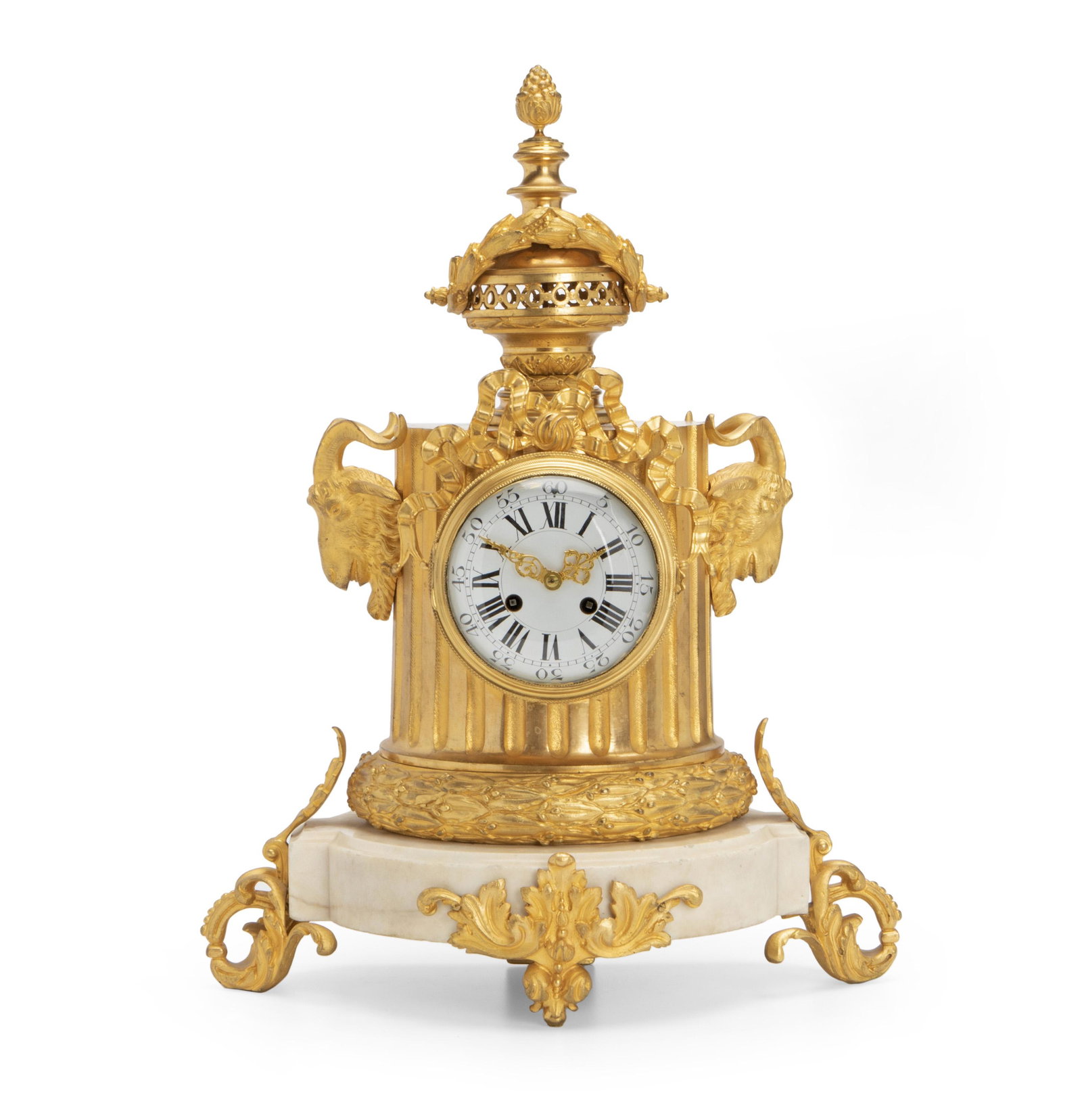 A French white marble and gilt bronze clock: Late-19th/early-20th Century Stamped: 1821/6 The white dial with Arabic and Roman numerals set in a bronze columnar-shaped body with rams heads, ribbons, and laurel leaf decoration under an acorn fini