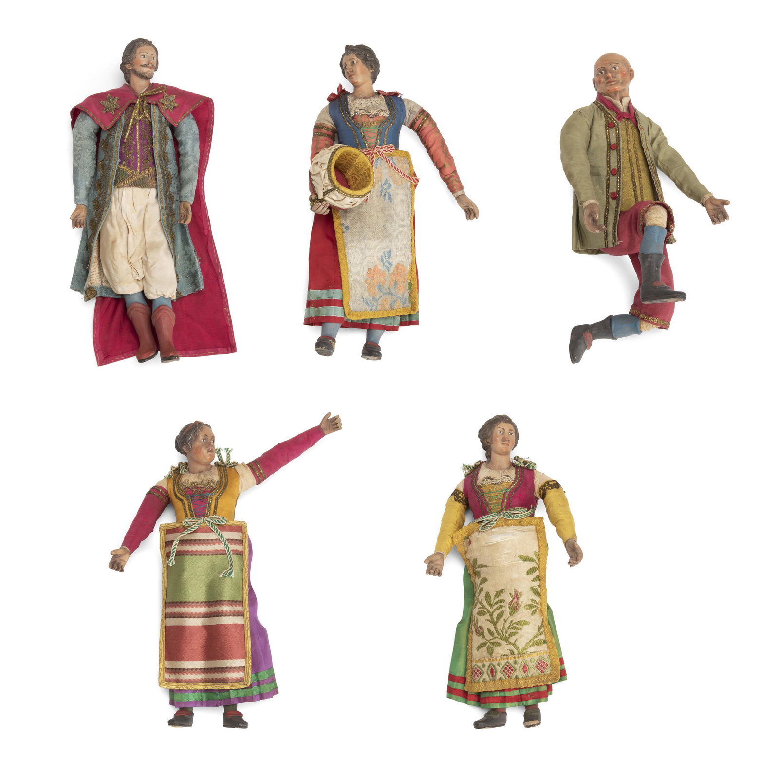 Five antique Neopolitan carved creche figures: 19th Century; Italian The five figures in traditional colorful dress with decorated skirts, embroidered aprons, bodices, and capes, and short pants, The skirts held in shape by sewn newsprint, 5 piece