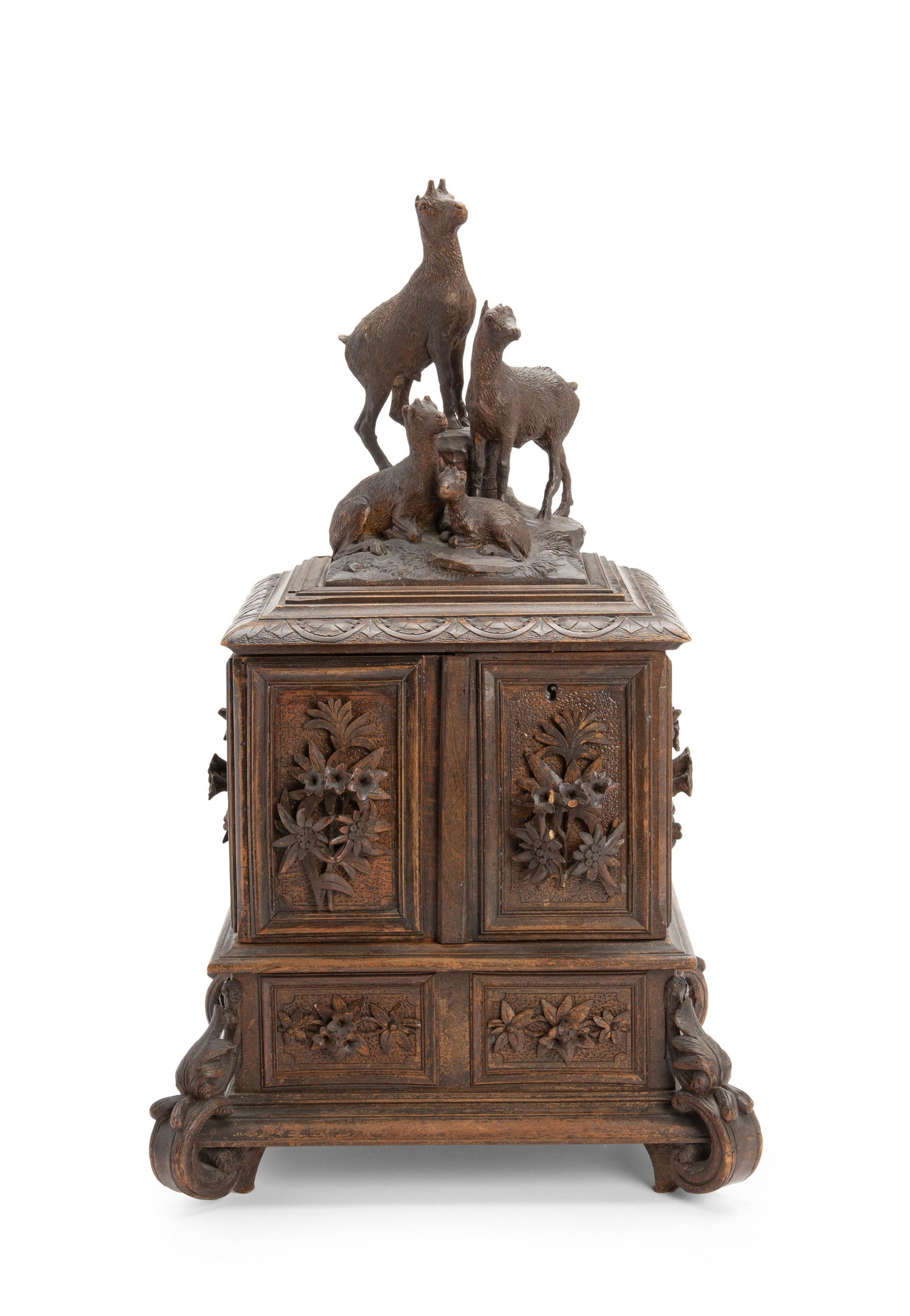 A German Black Forest jewelry chest: Late-19th/early-20th Century Carved wood with alpaca figures to top enclosing a blue silk-lined interior and three tiers of boxes and drawers on scrolled feet 21.5" H x 13" W x 13" D