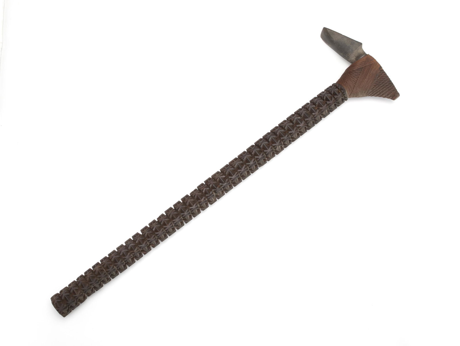 An Oceanic carved wood adze: Late-19th/early-20th Century; Mangaia Island, South Pacific The intricately carved wood and stone tool with sharp cutting edge most likely made for ceremonial purposes 31" H x 8.25" W x 2" D Provenanc