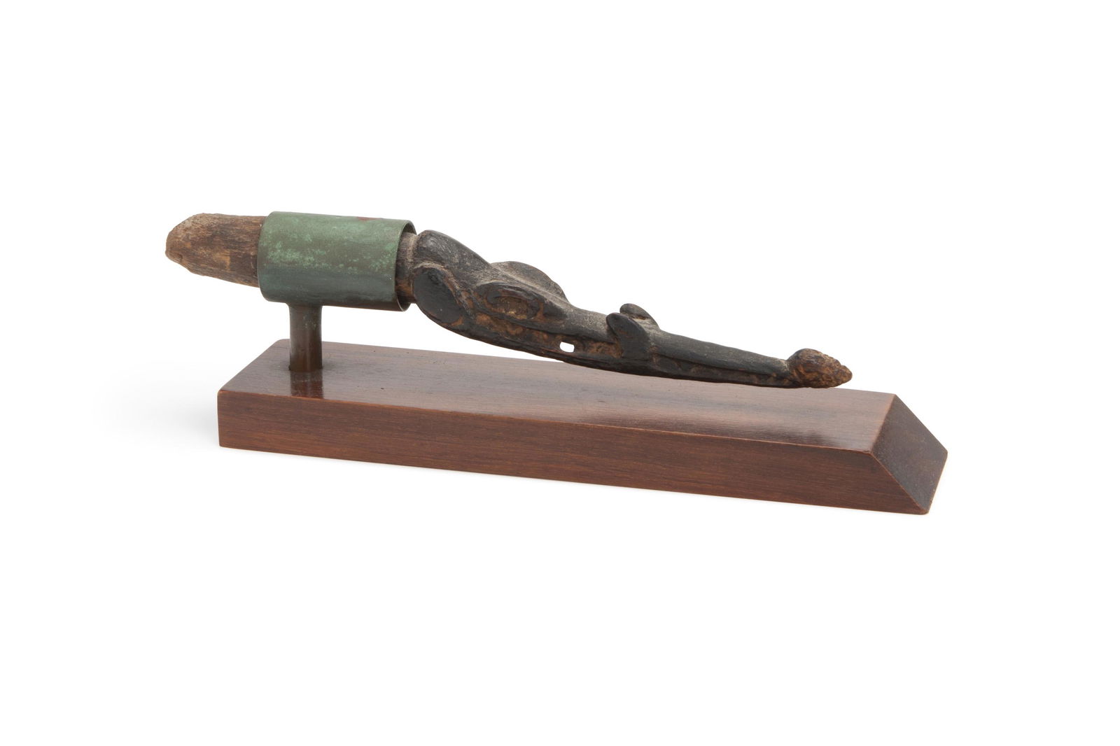 An Oceanic zoomorphic flute stop: Sepik River, Papua New Guinea The elongated crocodile-shaped flute stop atop a wood and metal stand 9.25" H x 1.25" W x 1.25" D Provenance: Collection of Marian and John Scott, gifted by Wayne Hea