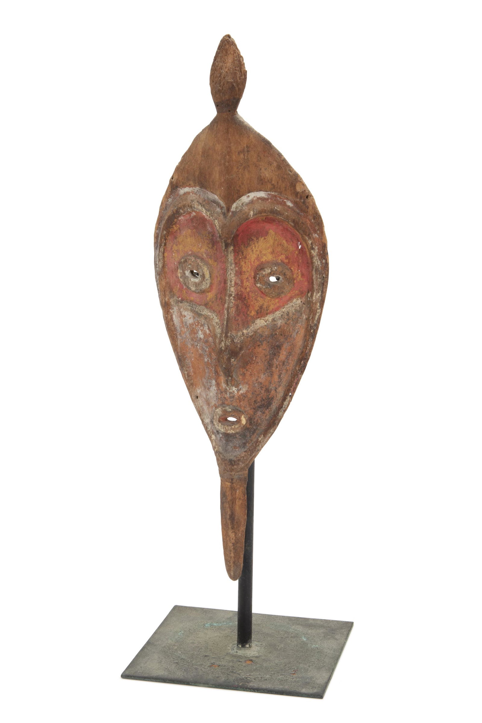 An Oceanic wooden face mask: Late-19th/early-20th century; Ramu River, Papua New Guinea The delicate wood heart-shaped face mask in pointed oval form with top and bottom terminal projections with trace red and white pigments, wit