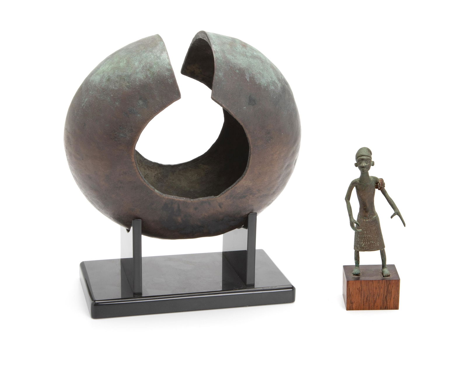 Two African bronze and copper items: 20th Century Comprising a copper currency anklet from the Democratic Republic of the Congo together with a small Dahomey cast bronze figure of a standing male with outstretched hands on a pedestal, 2