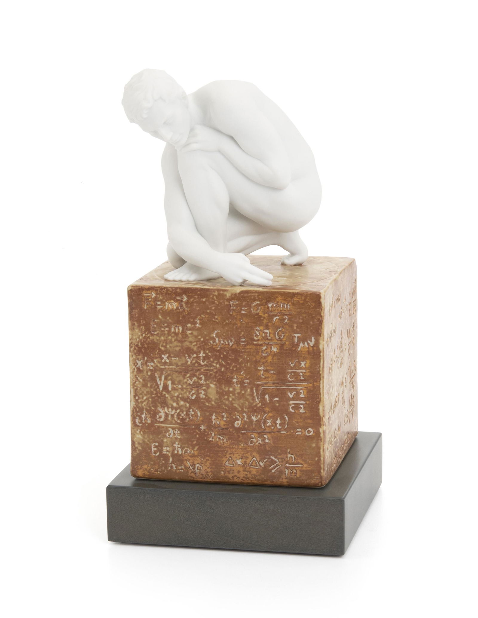 A Lladro "Scientia Man" porcelain figure: 2003 Marked: Lladro / Hand Made in Spain / Daisa / 2003 Depicting a nude figure of a crouching man drawing a circle with his two fingers while surmounting a painted cube marked with scientidic formu