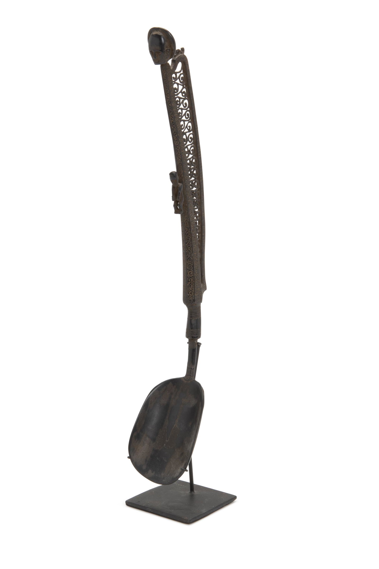 An Indonesian carved ceremonial spoon: East Timor The delicately carved horn spoon with lace patterned handle on stand 13.5" H x 2.5" W x 2" D Provenance: Collection of John and Marian Scott Acquired from the above by the present owner