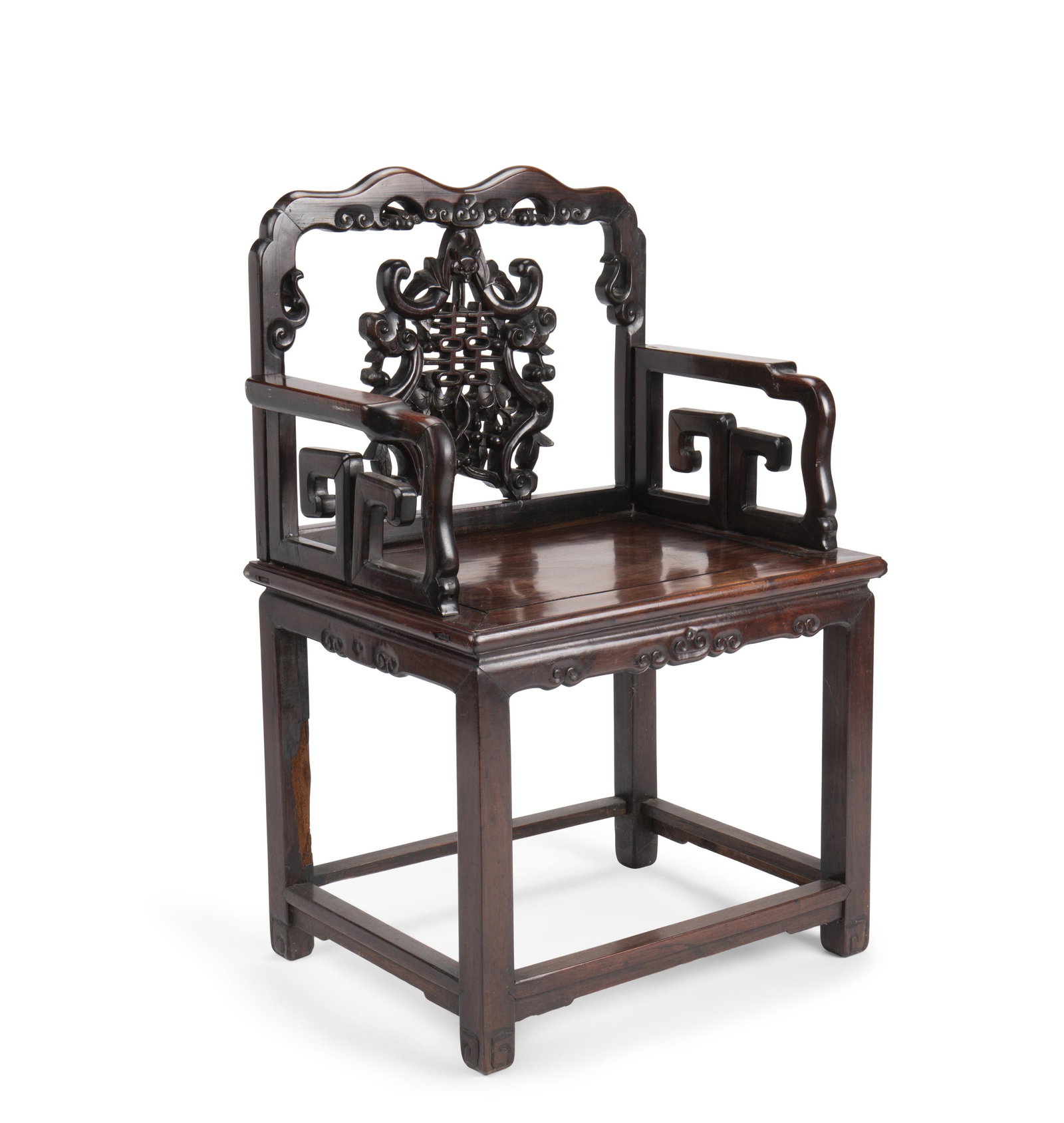A Chinese carved wood armchair: Second-half 20th Century The intricate carved wood back splat with animal and foliate motif over a wide rectangular seat, carved arms, and square pillar legs 38.5" H x 25.5" W x 18.5" D