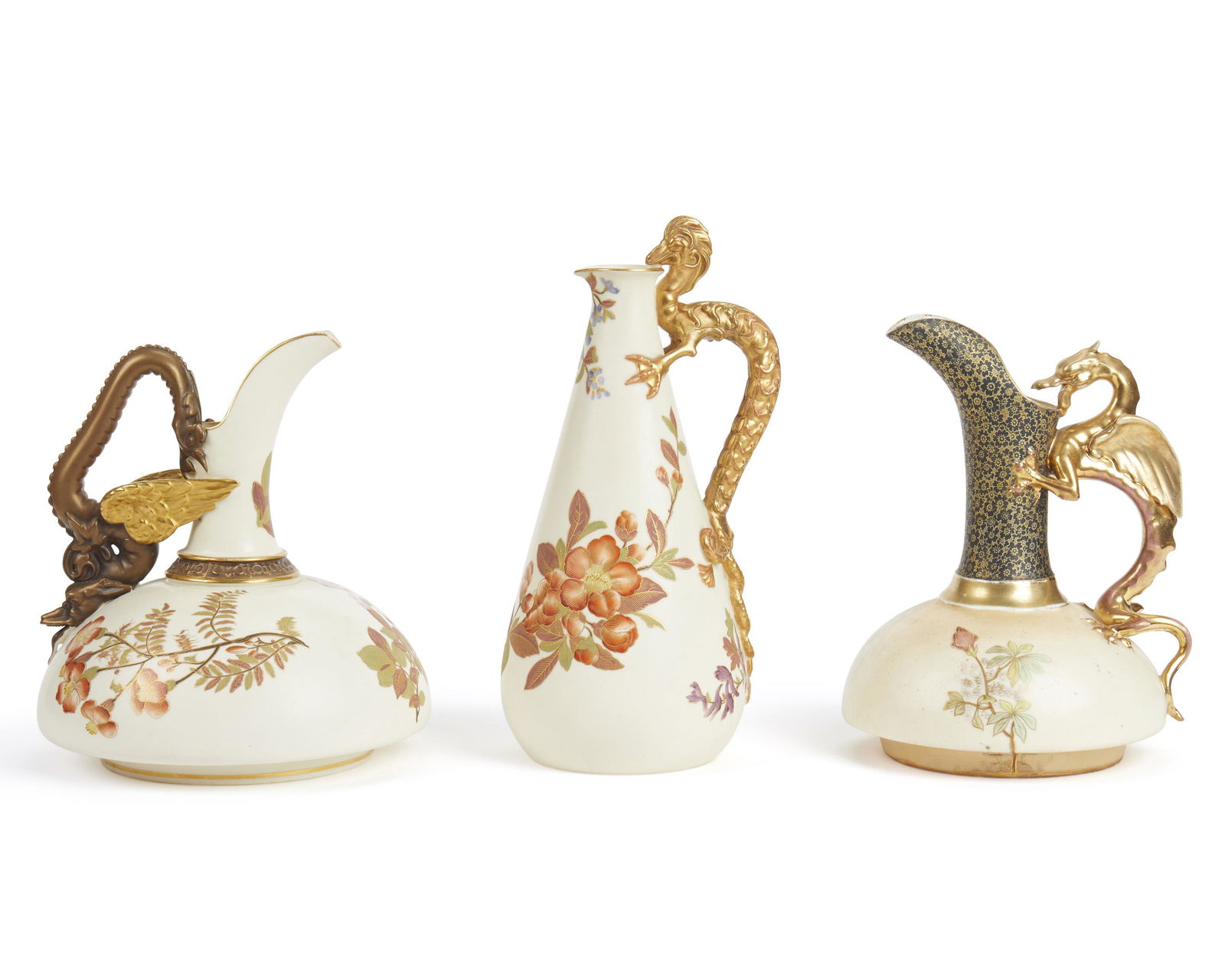 Three porcelain ewers: Late 19th/Early 20th century Various makers Comprising two Royal Worcester ewers each with gilded figural dragon handle, the first with painted floral sprays and purple overglaze crown mark "No. 686