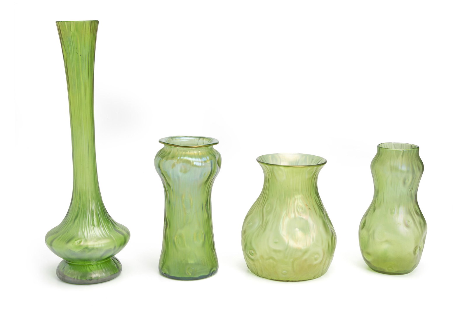 Four Loetz-style art glass vases: First-half 20th Century Each executed in iridescent green glass with a dimpled surface, one signed "Loetz" to the underside, 4 pieces. Tallest: 15.25" H x 5.25" Dia.