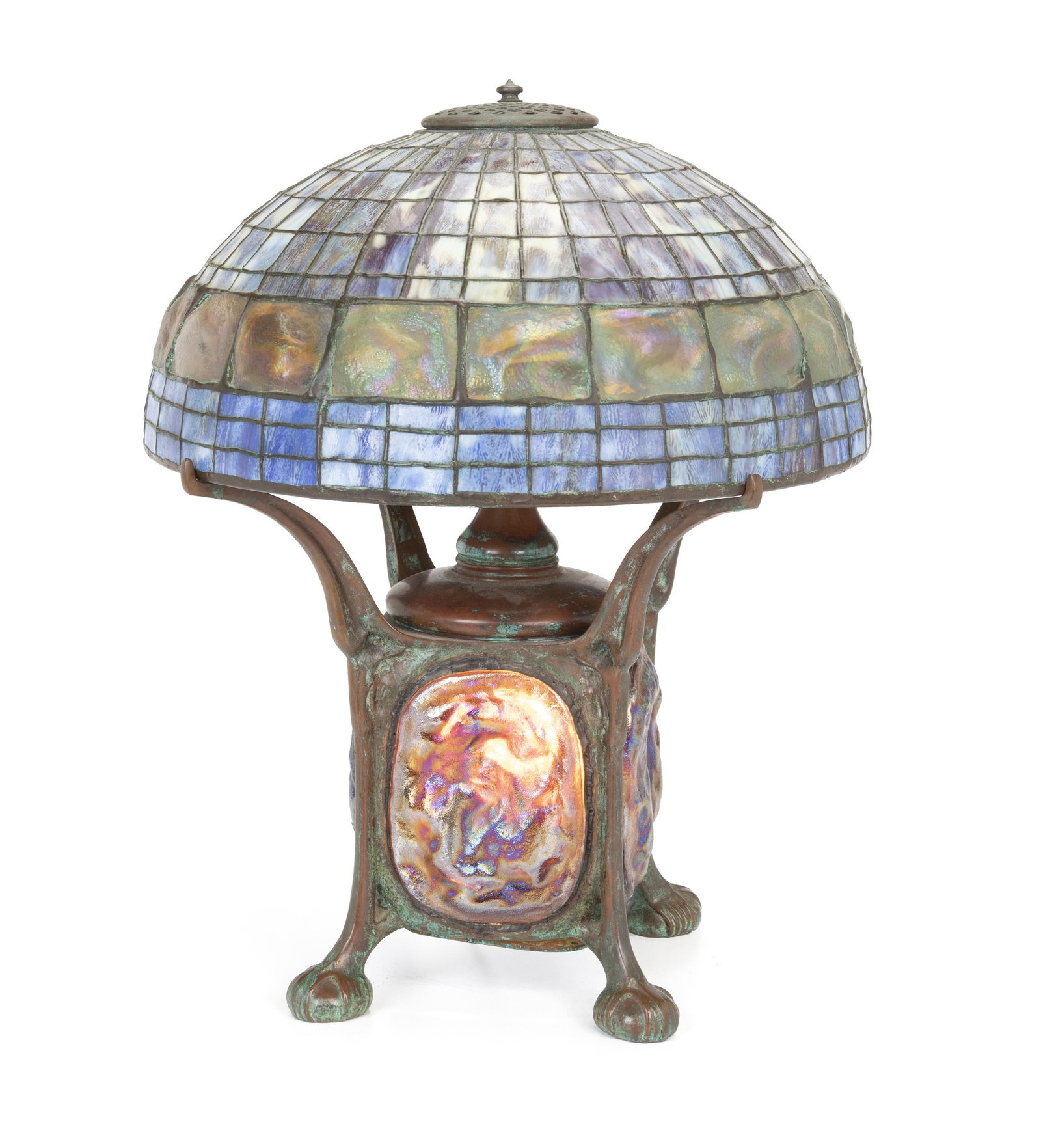 A Tiffany-style leaded glass table lamp: First-half 20th century Likely Art Glass Studio, apparently unsigned The turtle back-style shade and bronze base with iridescent glass panels on a three-light base 20" H x 16" Dia.