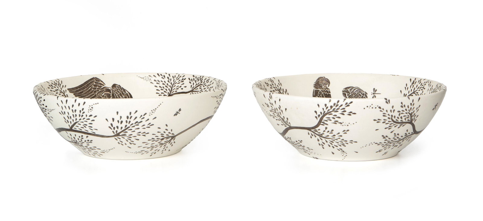 A pair of Emilia Castillo silver-inlaid bowls: Contemporary Each marked to base: Emilia Castillo MR / Plata Pura / Mexico 98 / [production number] Each of white earthenware enhanced with silver inlay of parrots, trees, and dragonflies, 2 pieces