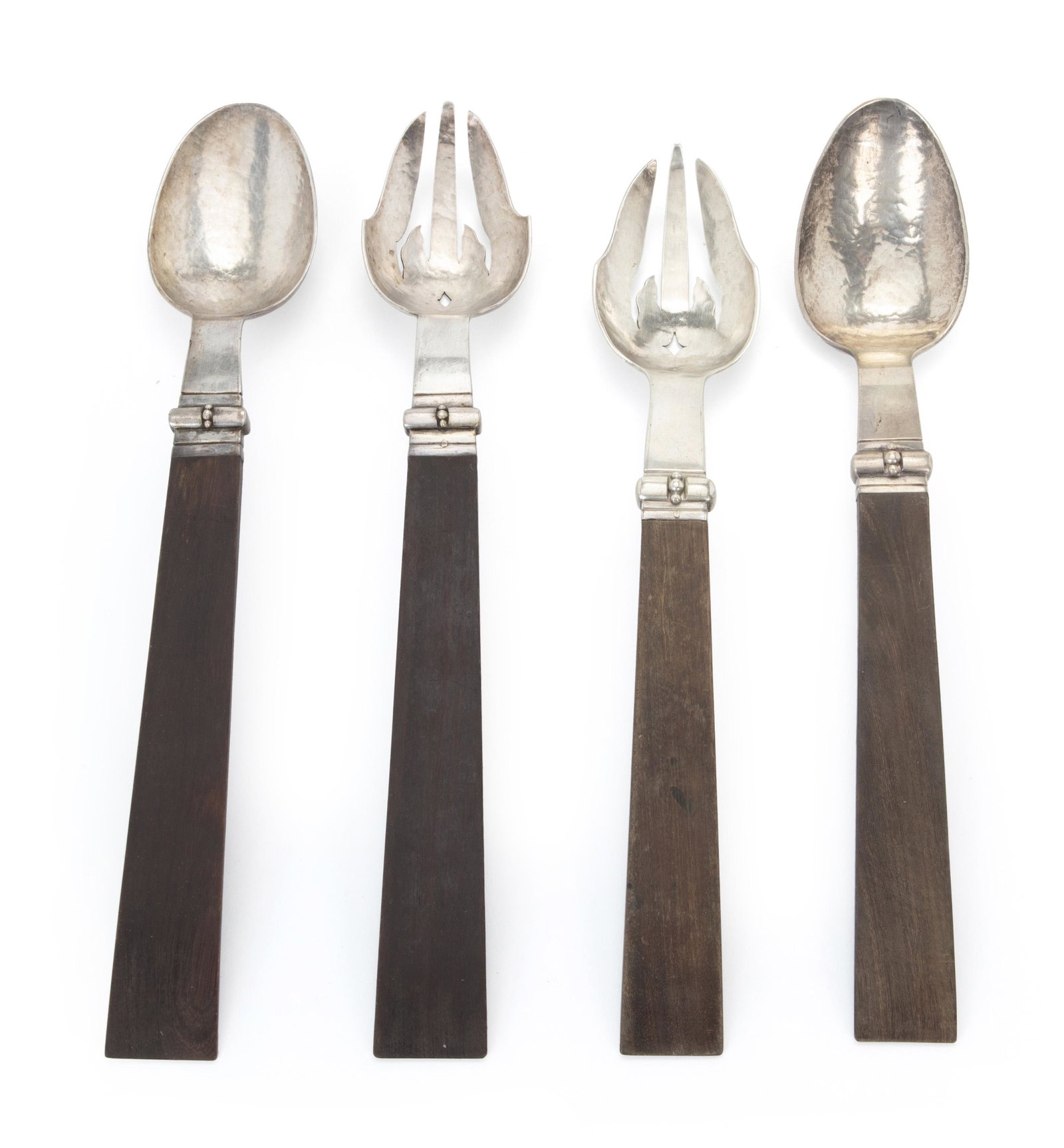Two William Spratling rosewood salad sets: 1933-1938 and 1940-1944; First Design Period; Taxco, Mexico Each stamped for William Spratling; One fork stamped: Spratling Silver; One fork stamped: 925 / Taxco Comprising two sets, 4 pieces Larger s
