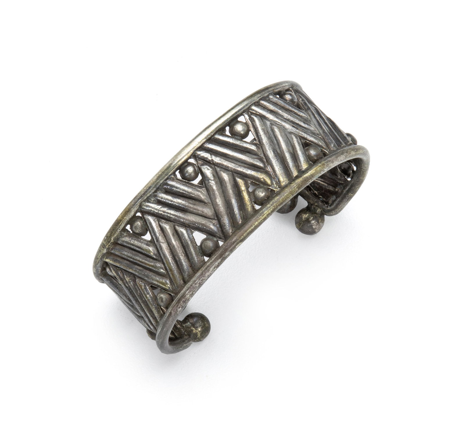 A William Spratling silver cuff bracelet: 1940-1946; First Design Period; Taxco, Mexico Stamped for William Spratling; Further stamped: Made in Mexico / silver The linear zig-zag design terminating with six silver balls 6.25" C x 1" H; Wrist 