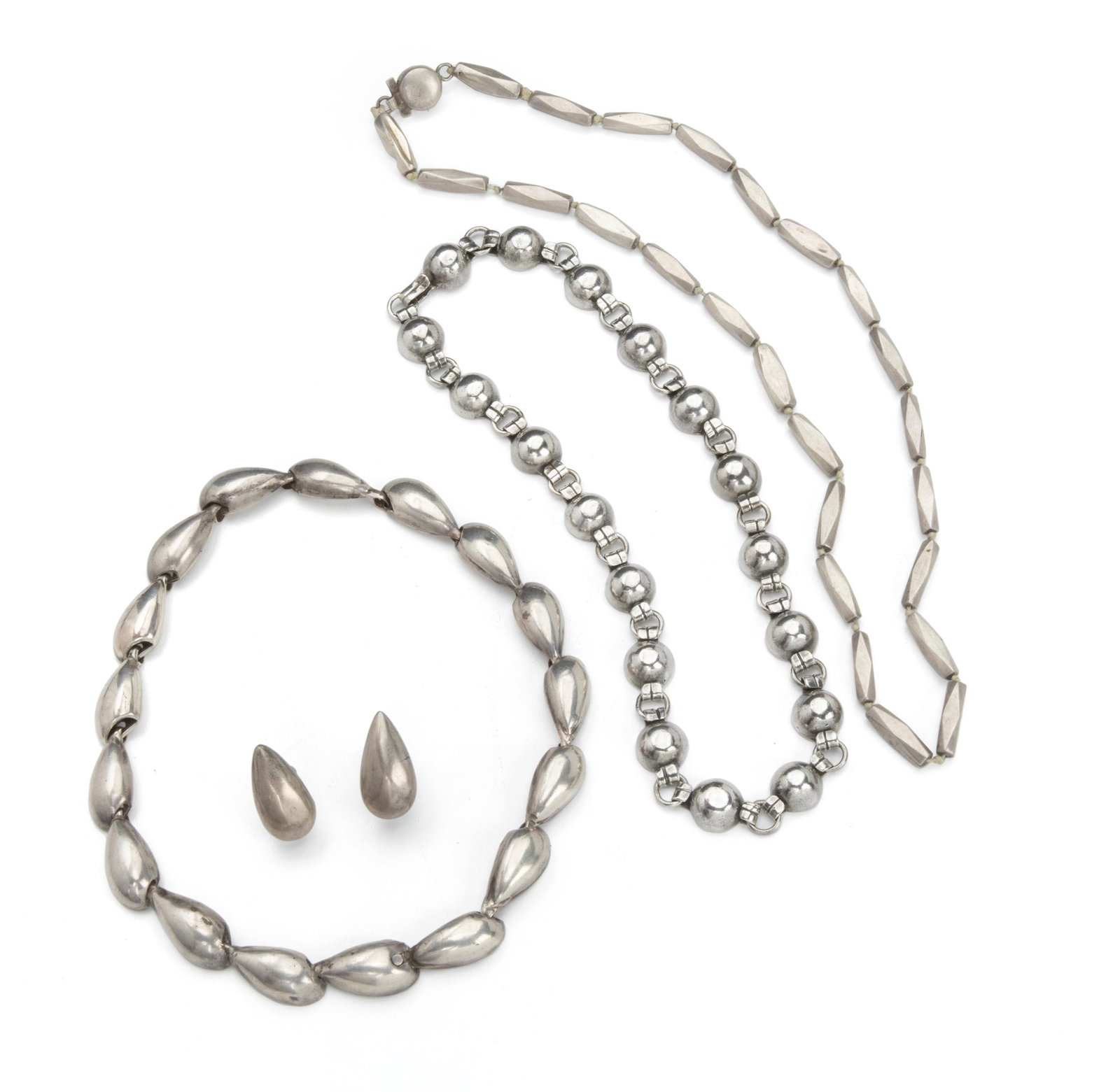 A group of William Spratling silver jewelry: 1933-1939 and 1940-1946; First Design Period; Taxco, Mexico Each stamped for William Spratling; Further stamped: Made in Mexico / Silver / Taxco / 980 Comprising a geometric link necklace (22" L x .25