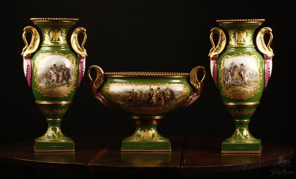 A Sevres style green ground garniture vases urn: With green overglaze interlaced ''L'' marks to undersides centered by an "S'' and further marked ''M. Imp ie / de Sevres'', comprising a double-handled urn (12'' x 17.5'' x 8'') and a pair of double-h