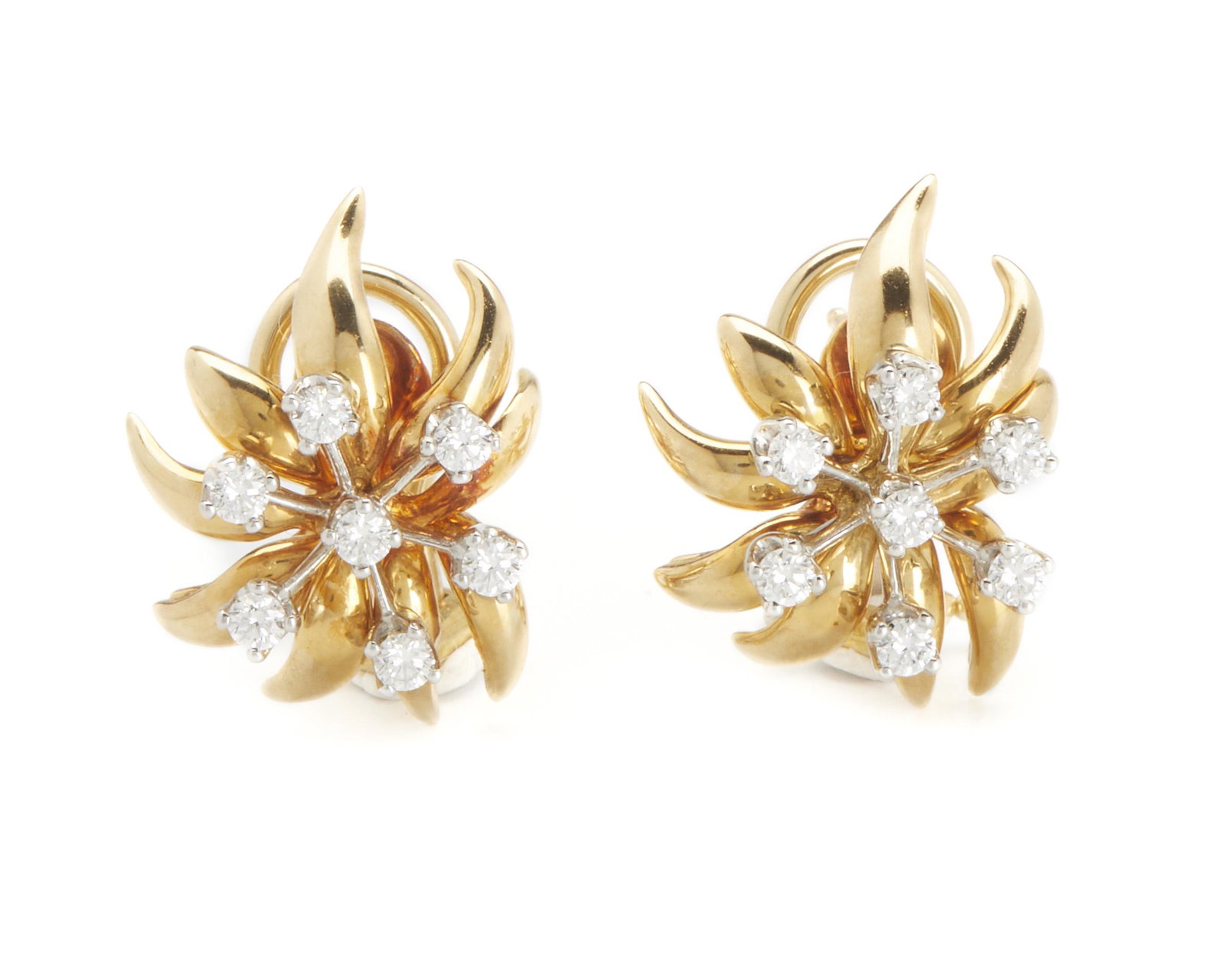A pair of Schlumberger for Tiffany & Co. diamond ear: Platinum and 18k yellow gold; Signed: Schlumberger Studios / Tiffany & Co. Each set with full-cut round diamonds totaling 0.55 cts. and graded G-H color, VS clarity in a floriform setting .875" H x .6