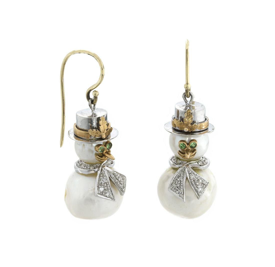 A pair of Italian South Sea cultured pearl snowman: Circa 1975, Napoli, Italy, 14k yellow gold Each hook earring suspending a cultured South Sea pearl snowman with yellow and white gold hat, emerald eyes, and diamond-set scarf 1" H x .625" Dia. 16.5 gr