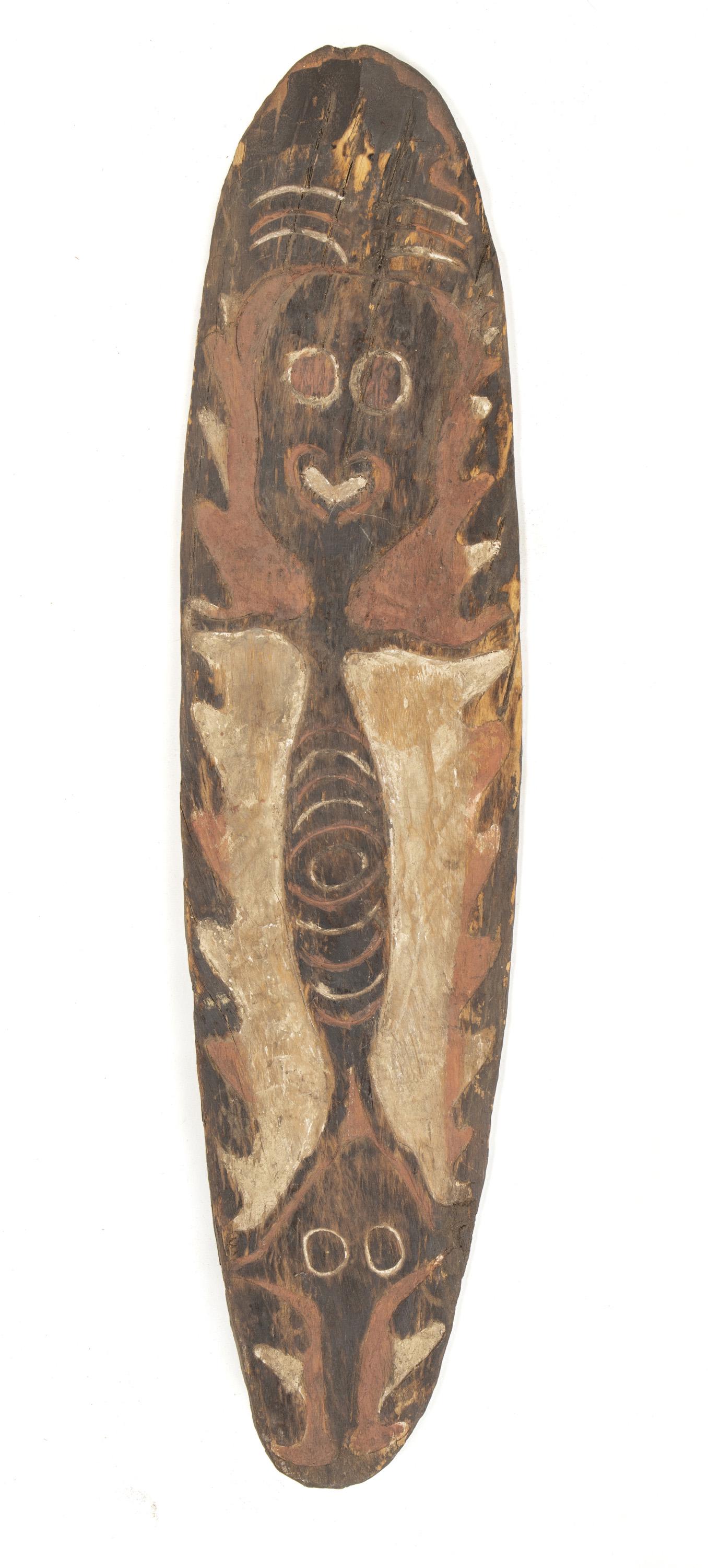 A "Gope" Papuan Gulf ancestor spirit board: First-quarter 20th Century; Papuan Gulf, Papua New Guinea The ovoid carved wood spirit board with figural motif and polychromed with natural pigments and charcoal 41.75" H x 10" W x 2.75" D Provenance
