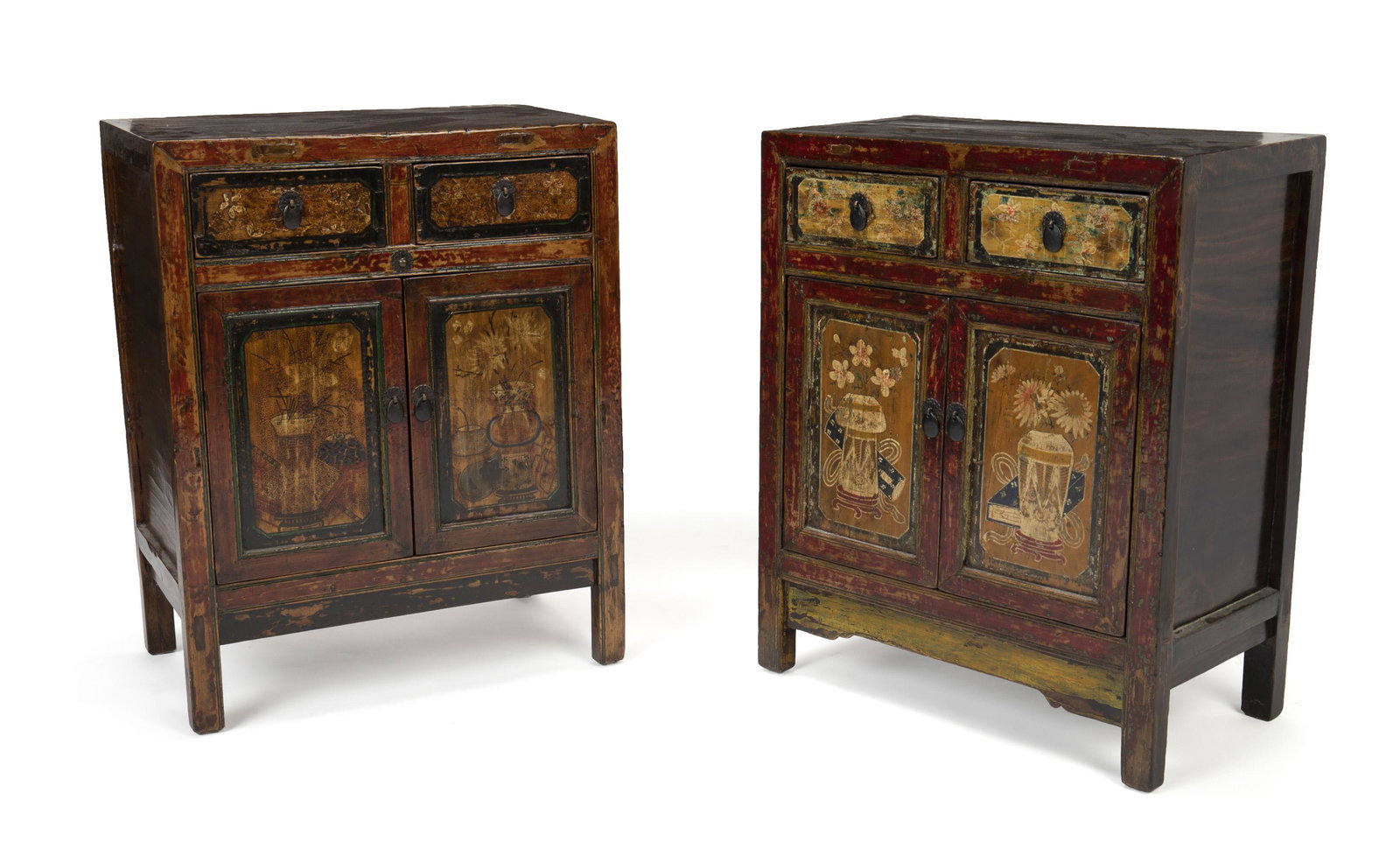 A near-pair of Indonesian nightstands: 20th Century The red-hued painted and lacquered wood nightstands with two drawers over a two-door cabinet body and shelved interior, with sunken panels decorated with floral and vase motifs surrounded