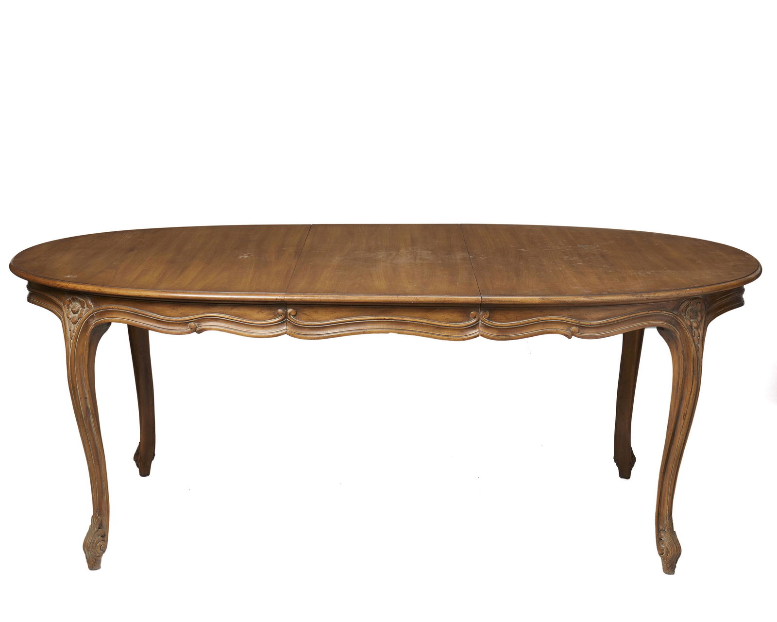 A Louis XV-style dining room table: First-quarter 20th Century Carved wood body with one extension leaf over carved flower and scroll cabriole legs Extended: 29.5" H x 77.25" W x 41.5" D; Closed: 29.5" H x 59.5" W x 41.5" D