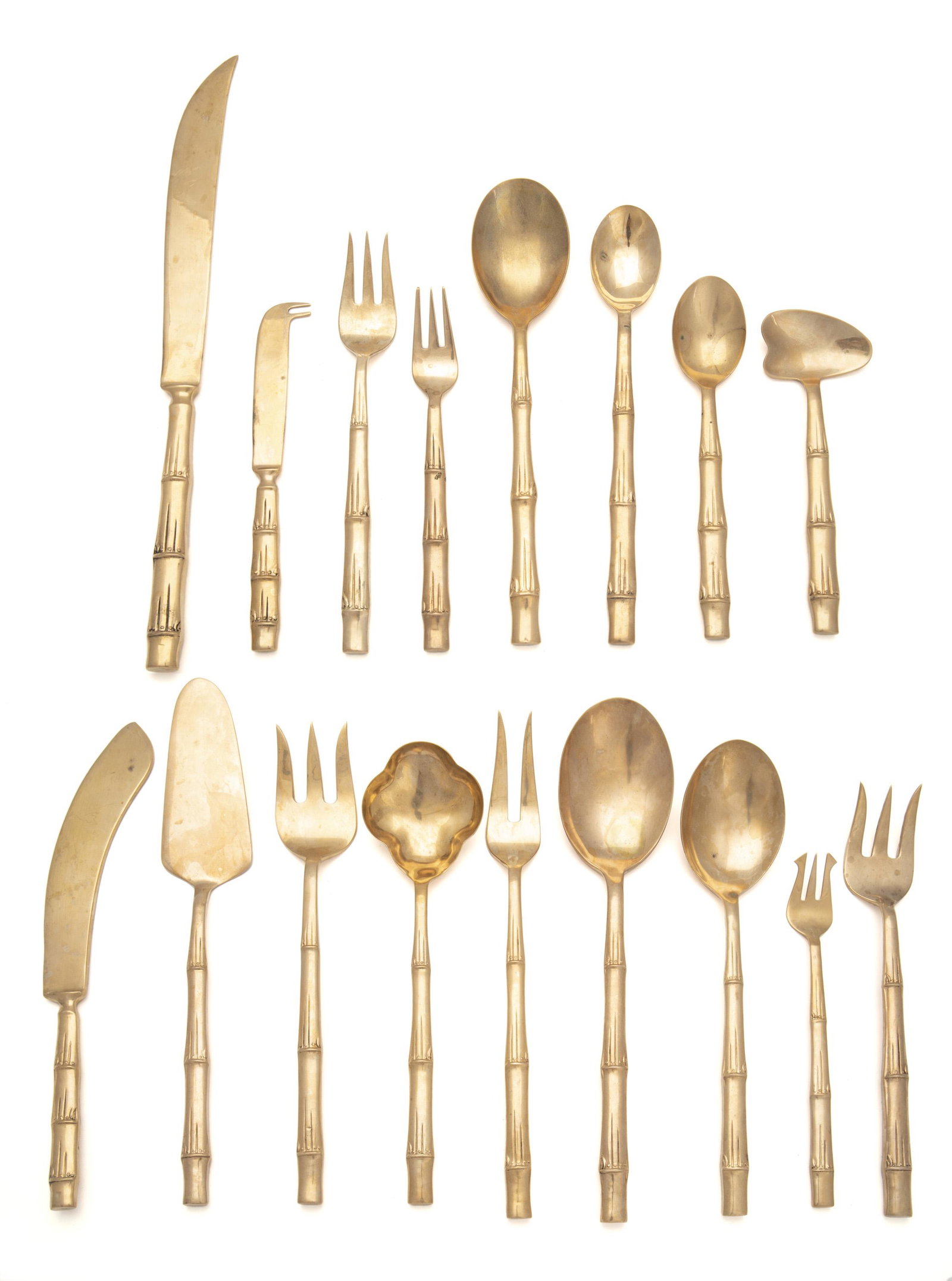 A Thai gilt-bronze flatware service: Third-quarter 20th Century Each marked Each with bamboo motif, comprising 8 place knives (8.875"), 8 steak knives (8.25"), 8 butter spreaders (5.75"), 7 place forks (7.75"), 8 luncheon forks (7.25"), 