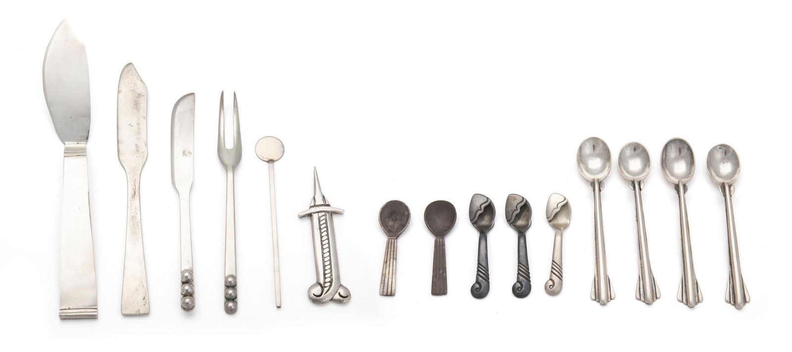 A group of silver table accessories: First-half 20th Century Most marked for sterling Of various makers comprising one Allan Adler "Starlit" butter spreader (6"), one Allan Adler cocktail stirrer (3.875"), one Mexican cheese knife (5.1