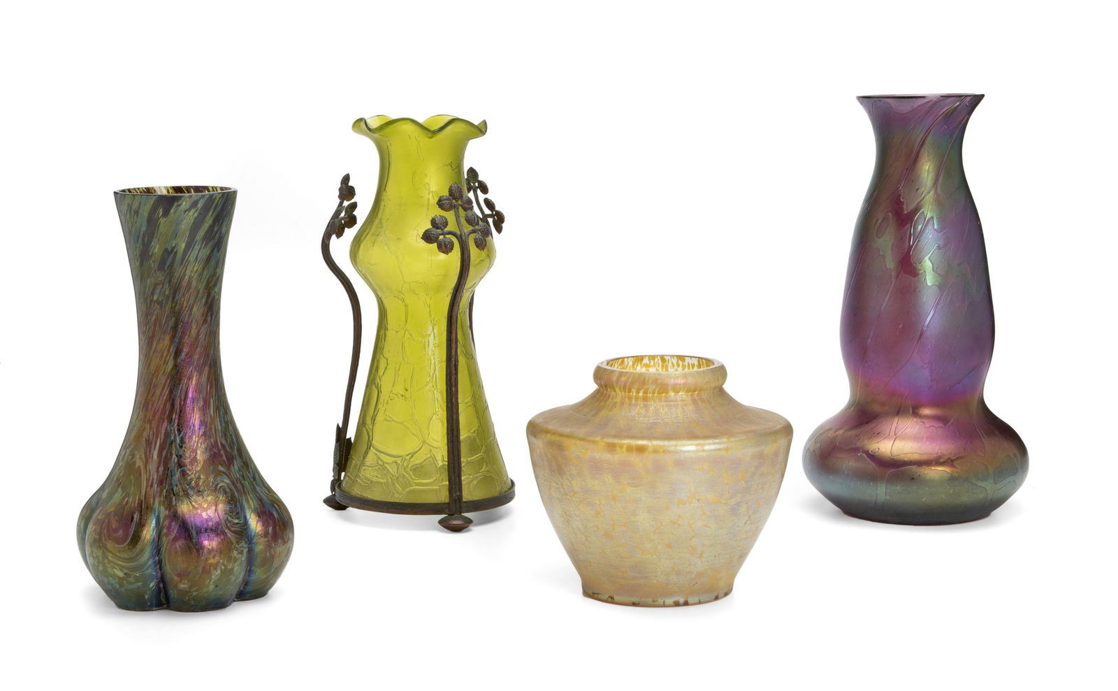 Four Loetz iridescent glass vases: Late 19th/early 20th Century Shortest signed for Loetz: [Arrows] / Austria Comprising two multi-color purple vases with bulbous bases and tapered necks, one green vase with ribbon rim, graduated nec
