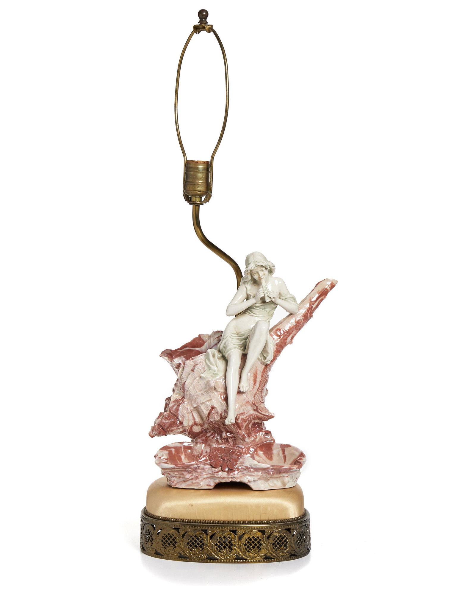 A Royal Dux Art Nouveau figural lamp: Late 19th/early 20th Century The seated figure of a lady with a flute on a shell and dish attached to a satin and bronze based lamp Overall: 27.25" H x 10" W x 9.5" D; Figure: 12" H x 10" W x 8.5" D