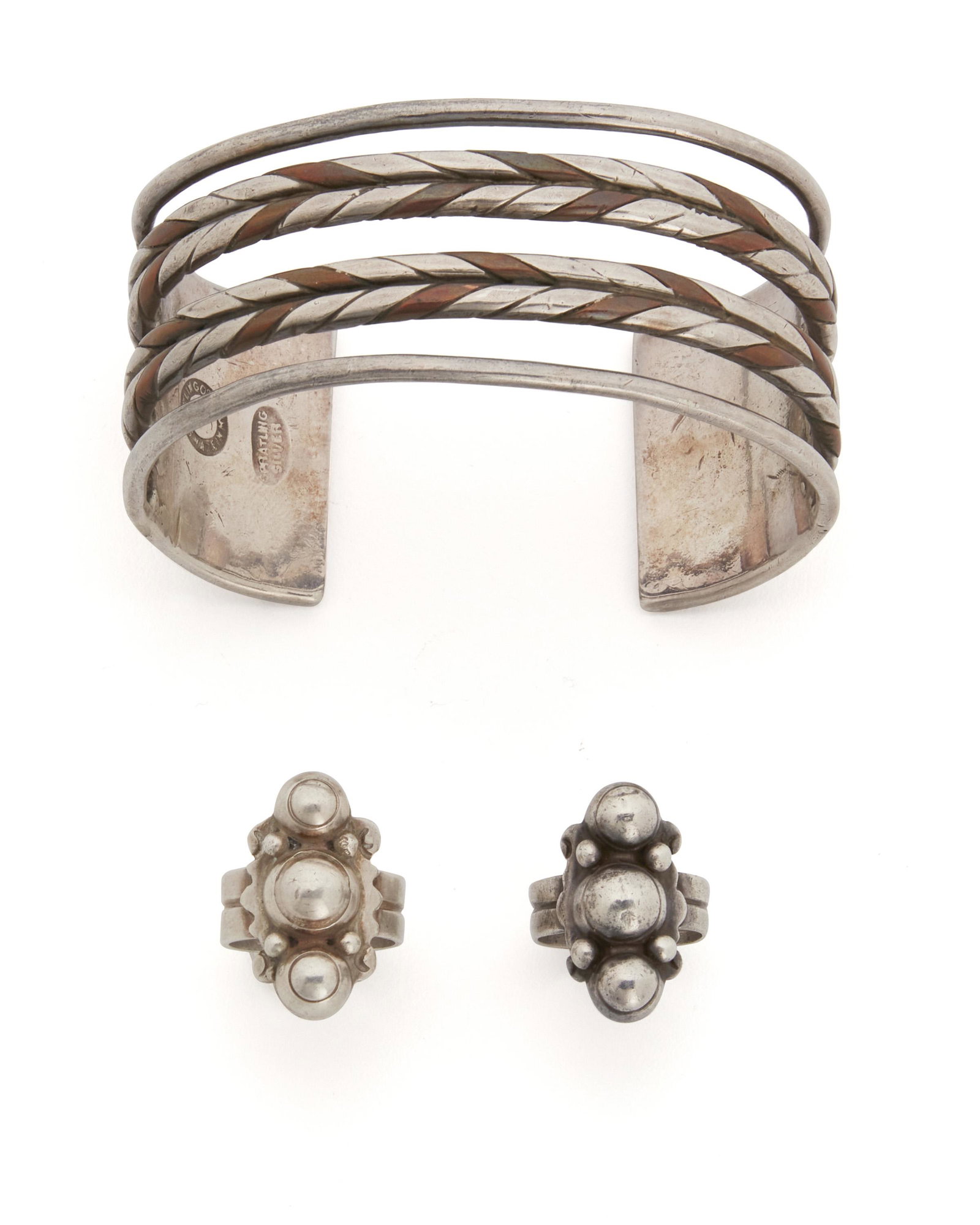 A group of William Spratling silver jewelry: 1933-1939 and 1940-1946; First Design Period; Taxco, Mexico Each stamped for William Spratling; Others variously stamped: 980 / Taxco / Made in Mexico / Silver Comprising a wide cuff bracelet with bra